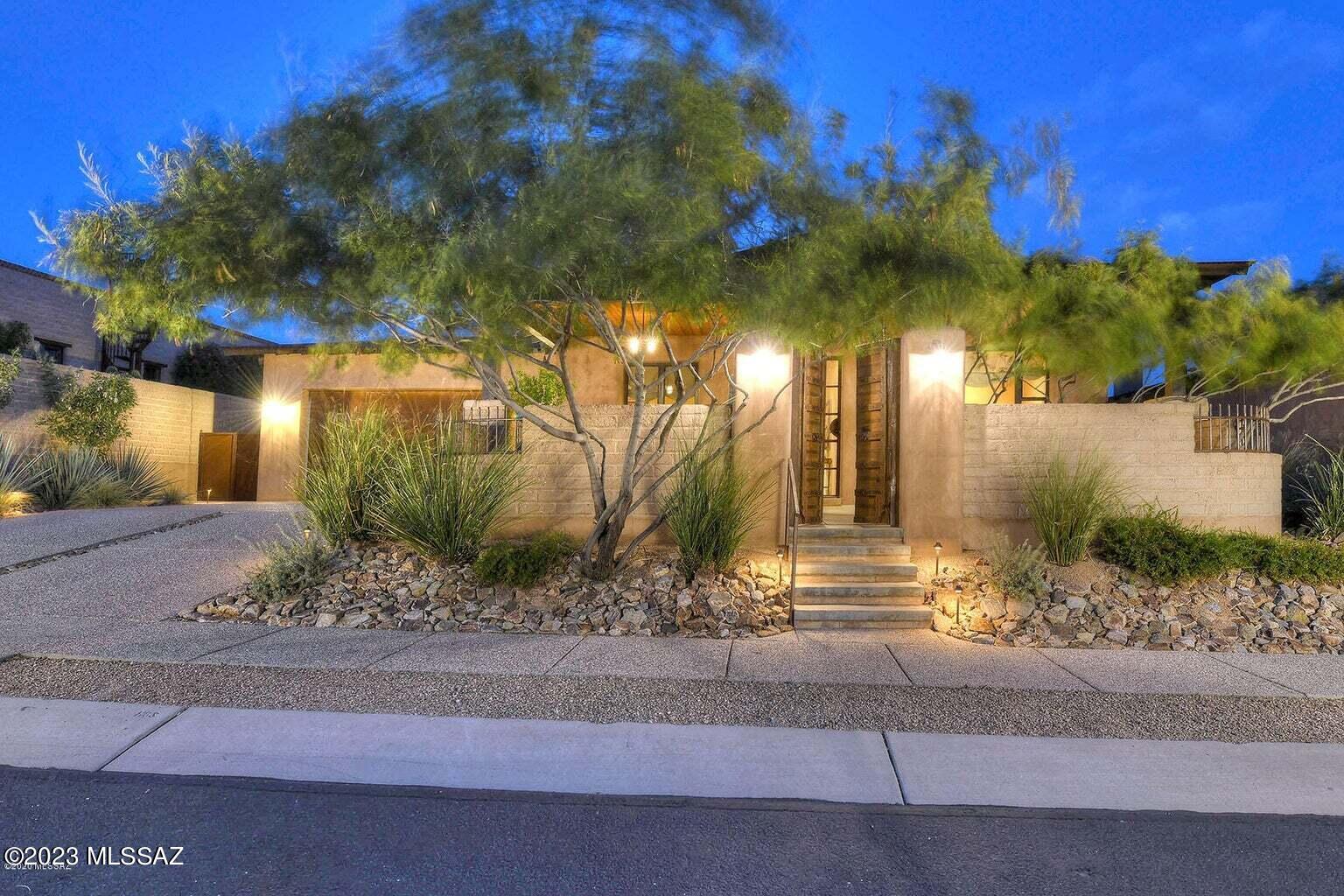 Stunning Stellar Gray built home in the gated SkyRanch community.  Unmatched construction and design pair with gorgeous Catalina mountain views and private open space to create a uniquely impressive home.  Featuring Rasta Block (ICF) construction, steel roof and polished concrete floors.  Inside the elegance of hand plastered walls, cedar planked ceilings, Metropolitan quartz counters and quartzite kitchen island, Thermador and DCS appliances, authentic antique doors at Primary bedroom and Office will leave you in awe! Outdoors you'll find the perfect space for relaxing or entertaining from the beautifully landscaped backyard and patio with raised firepit, mountain views and lots of privacy. A true southwestern beauty!