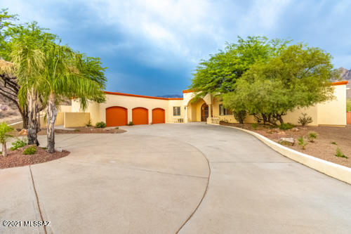Purple Mountain Majesty Views! 

Private Desert Surrounds And Majestic Pusch Ridge Mtn View on 1.22 acres. 

The flowing floorplan provides a view from most rooms. Open gourmet kitchen with granite counters, stainless steel appliances, gas viking range, wine refrigerator, custom mesquite counter island, pantry and breakfast nook. Great room off kitchen with gas fireplace. Formal living and dining rooms. Custom wood interior doors throughout 3 car garage with large storage room. 

Perfect home for entertaining or just relaxing in the professionally landscaped backyard soaking in the views. Built in BBQ, fire pit, sunken spa, putting green, teebox and additional elevated cozy seating area.