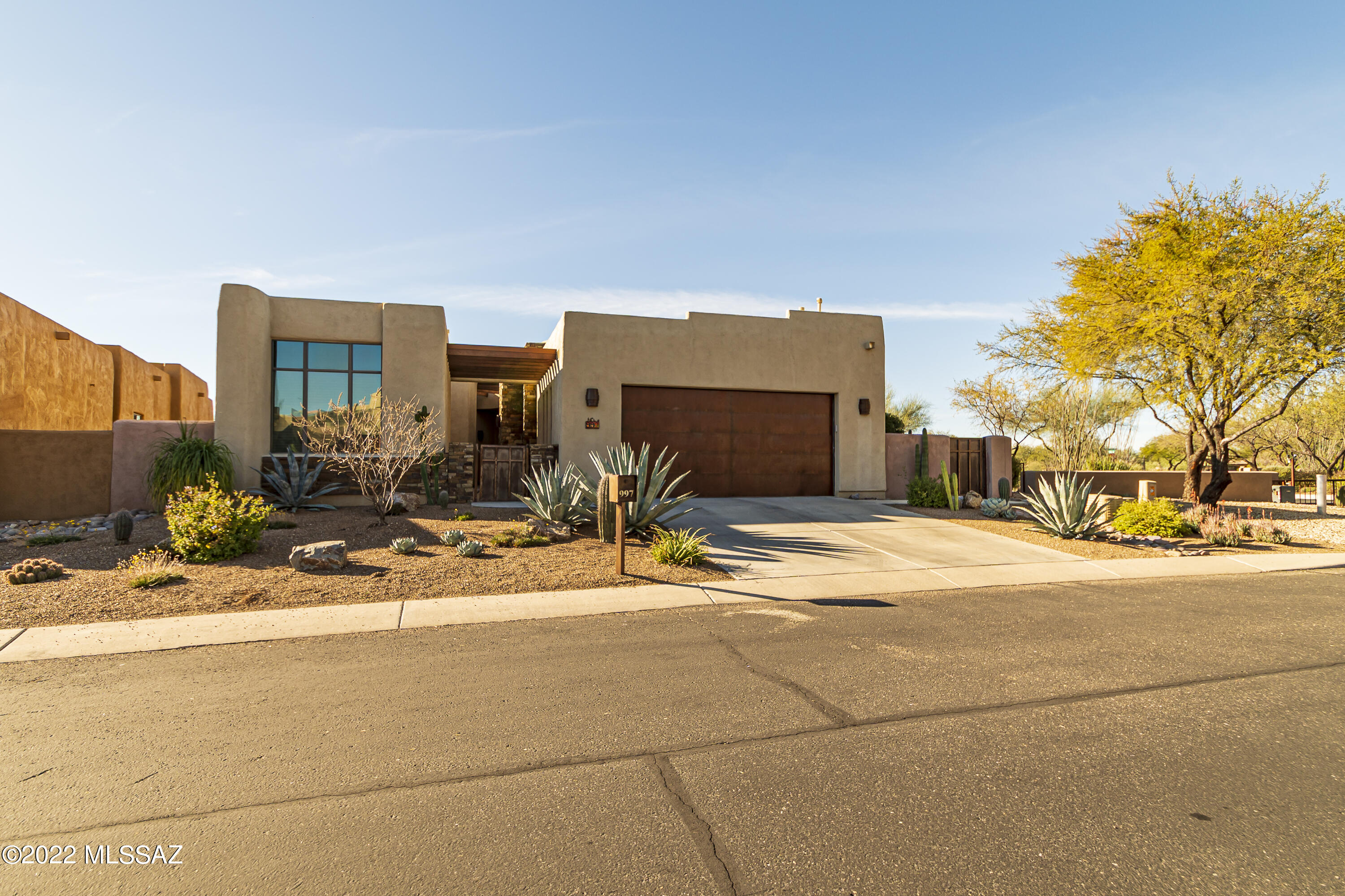 This relaxing back yard was featured in Tucson Life Style magazine in 2017.  A bathroom in every bedroom including the casita.  4 bedrooms 5 baths. Achitecturally stunning home designed by renowned Tucson architect Kevin Howard. Nestled within thegated community of Stone Village. Welcome to teh open concept great room with 9' ceiling, curved walls, tall windows with a cozy gas fire place. Your love the grand chefs kitchen features high-end stainless appliances with a huge island for your entertaining pleasure, and 2 wine collers, seperate dining area with a built-in buffet . Owners retreat freatures built-in cabinetry with a luxurious spa lilke bathroom. The two specious bedrooms each have delux ensuit batrooms.  All potted plants in back yard stay. Casita is 273.19 sq ft. Main home 2589.1 sq. ft. Total feet 2863 sq. ft. Solar spool heater with thermal energy tubes from the sun.  Here is your chance... We say "Don't Delay"' This home will be Going... Going... Gone.