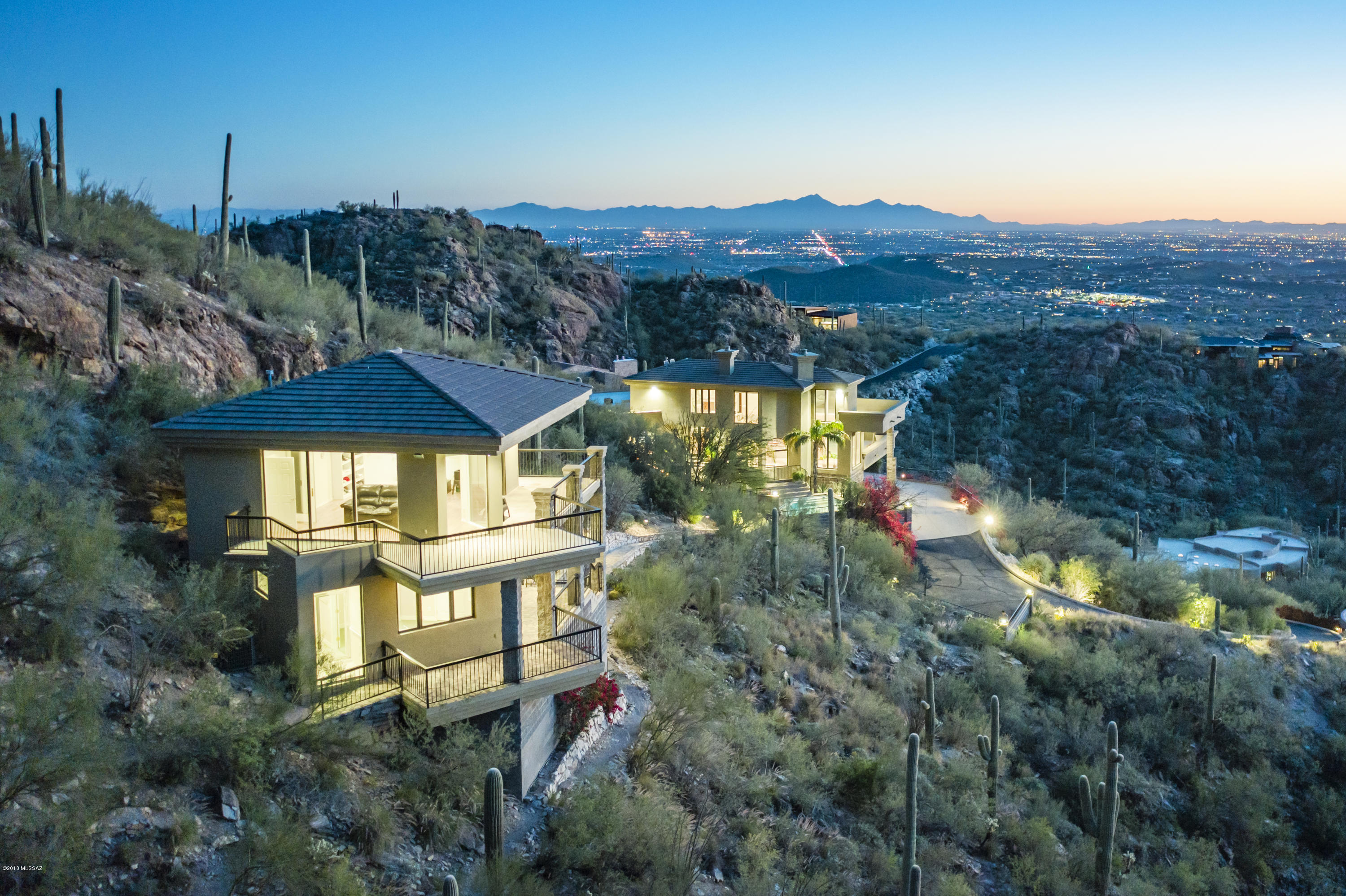 TOP OF THE WORLD VIEWS in Coveted Ventana Canyon Mountain Estates! Located on over 6.5 Acres w/Private Hiking Trails, Water Falls, & Pristine Rock Formations, this Stunning Retreat Offers The Ultimate in Privacy & Views.The 3BR/3BA Main House (3,827 SqFt) Features Travertine & Oak Floors, an Updated Kitchen w/SubZero Ref.,Wine Ref., & Viking Stove, all Opening up to a Great Rm w/Fireplace.The Living Rm & Dining Rm Feature a Stacked Stone Fireplace, Oversized Picture Windows & Wrap Around Balcony. The Top Floor Master Suite Includes a Sitting Area,Fireplace,Updated Bath,& Private Terrace. The 1 BR/2BA (970 SqFt) Detached Guest House Features a Living Room, Kitchen,Office, & Balcony. Other Features Include:Pool,Rolling Shutters,2.5 Bay Garage,& Dumb Waiter.Unmatched City & Mountain Views!
