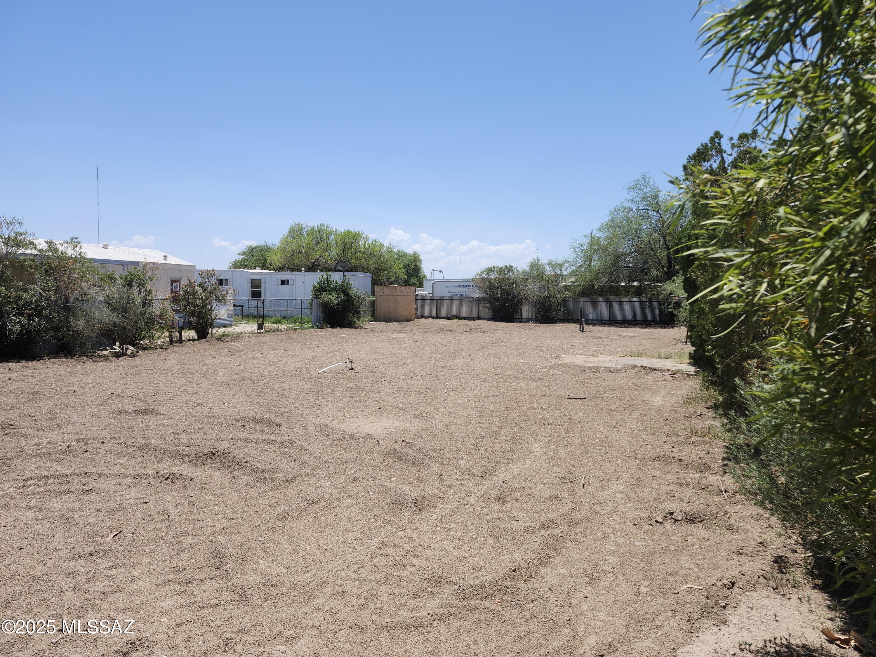 Great opportunity to purchase 0.25 acre lot for a MFH in a central location. Previous home was removed, and the lot is ready for your own personal touches and new manufactured home. Great two car carport at front of lot, and entire lot is fenced with gate for secure access. Conveniently located minutes away from shopping, dining, the Rillito River walk/loop and easy access to I-10. Property serviced by electric, sewer, water and gas. Buyer to verify location of utilities.