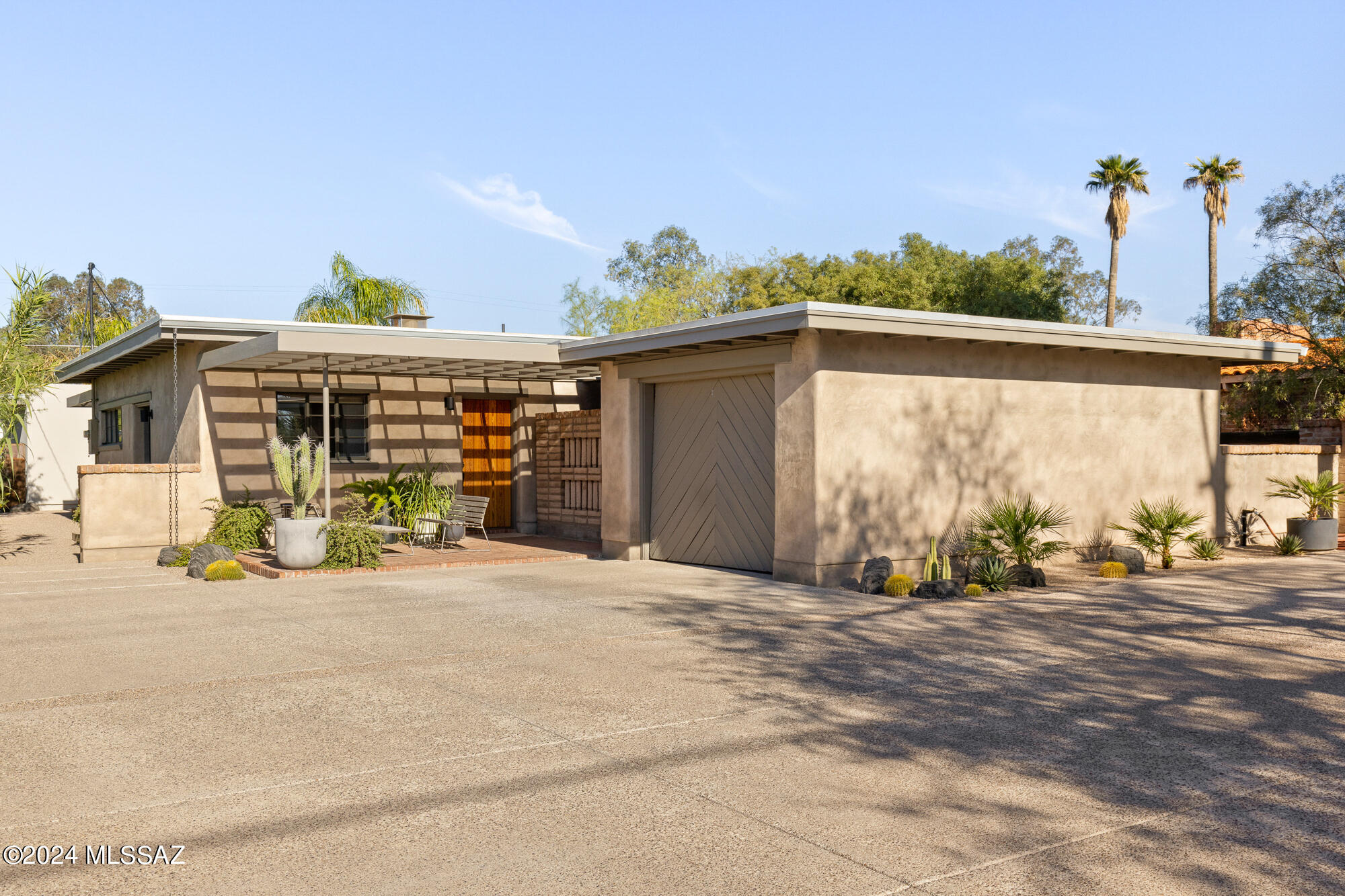 Designed by renowned architect Josias Joesler and built by John Murphy for his son Robert. This house was one of Joeslers last residential designs before he passed away in 1956. Working in collaboration with the owners, Hazelbaker Rush & Baer Works updated the home in 2021-2022 with the intention of preserving the historical character while honoring the Architect's original intentions. Compact in footprint, and spacious in proportions and measure, this home has been thoughtfully updated. Enter through the foyer into a dramatic open plan great room - with a corner fireplace anchoring the room, original pasta tile floors, carved wood beams, and wood ceilings throughout. The seamless transition between the great room, dining area, and kitchen, complemented by adjoining outdoor spaces, makes this home perfect for hosting gatherings and entertaining guests.