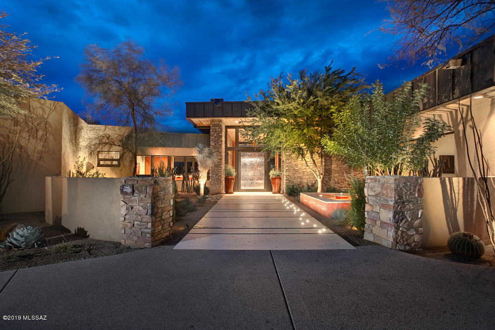 Motivated Seller says BRING ALL OFFERS! Owner will accept or counter offers between $1,995,000-$2,995,000. A rare offering to live on site behind the private gates of the world renowned Canyon Ranch Health Spa. This stunning contemporary masterpiece built by John Campisano sits on one of the best view lots in Canyon Ranch & backs to Sabino Creek. The timeless architecture & designer finishes embody luxurious southwest living from the stone accents in the expansive great room to the walls of glass framing the spectacular views. Natural stone floors, wood ceilings & custom details accentuate the dramatic & modern design. The gourmet kitchen features a mesquite butcher block island, stainless appliances & overlooks the negative edge pool/spa. 4 lavish bedroom suites + office, 3 car garage.