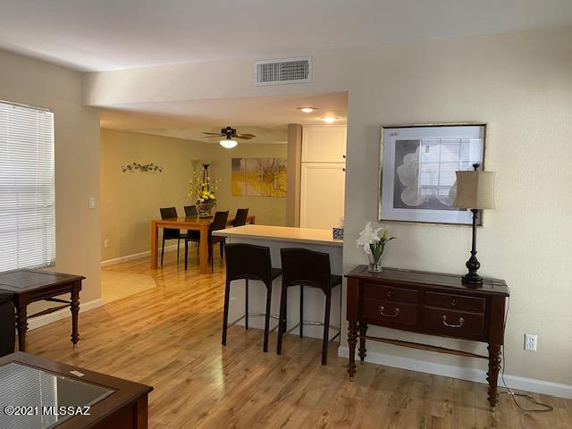 Stylishly updated 1bd/1ba downstairs condo. Conveniently located near La Encantada, art galleries and fine dining. This posh residence boasts a newer modern kitchen designed by Davis Kitchens, Corian counters, breakfast bar and newer appliances. Dining room features a dramatic tray ceiling. Updates include HVAC, flooring, hot water heater, bathroom vanity, counter top and tub. The bedroom features sliding door to patio, vanity and built-ins. FP in living room. Covered patio with mountain views and storage. Awesome club house with exercise facilities,tennis and spa-like pool w/intense mountain views. HOA fee includes;roof,fire insurance, trash, termite, & building exterior. This is care free living..