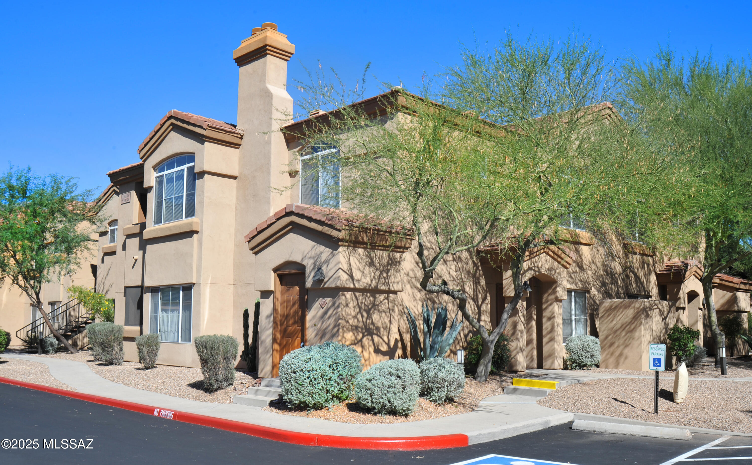 Charming two-bedroom, two-bath condo in the desirable gated community of Pinnacle Canyon! This move-in ready home features fresh two-tone paint, new carpet, and all-new energy-efficient stainless steel appliances. The open-concept floor plan offers a cozy wood-burning fireplace, a dining nook, a charming kitchen with granite tile countertops. Spacious primary bedroom with a large walk-in closet and access to the private balcony to enjoy the sunsets. Enjoy resort-style living with community amenities that include a heated pool & spa, large clubhouse, and fitness center, BBQ areas, and beautifully maintained grounds. Conveniently located near shopping, dining, and outdoor recreation including Sabino Canyon,  a perfect place to call home or a low-maintenance getaway gated to lock and leave!