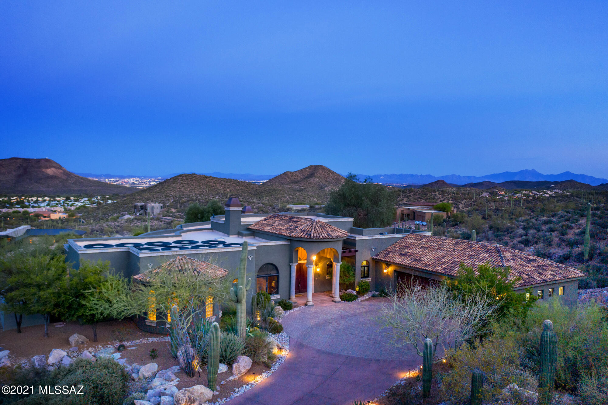 Overlooking the entire city of Tucson, this custom home is nestled at the end of a private cul-de-sac lot situated on 3.3 acres within the gated community of The Estates at Star Pass. A welcoming property with its distinctive drive into the 8 home neighborhood; enter through the serene courtyard and double entry Knotty Alder front door into the home. Notice the beautifully designed custom 3 bed, 4 bath, 4,361 sqft,, 3 car garage, with sweeping city & mountain views, surrounded Majestic Saguaros. An entertainers ideal setting with interior architectural features to include: extensive use of glass wall windows to enhance the dramatic city views, open concept floorplan, soaring coffered 15' ceilings, custom tile thru-out, travertine floors, 180° wrap around patio, Canterra Stone accents... The kitchen is the perfect complement to the traditional benefits of an open, airy gourmet kitchen space with top-of-the-line stainless steel appliances; sub-zero refrigerator, an impressive granite slab island, granite slab back splash, with gas cook-top, and custom soft close cabinets. A comfortable great room lies adjacent to the kitchen, containing a warming Canterra stone fireplace and convenient access to the back patio through double French doors. The primary suite is a place of true tranquility with private access through double French doors to pool/spa area. It features a luxurious seating area, exercise room, huge changing closet, a magnificent lavish bathroom with a double headed shower, granite slab counters, tile back splash, soaking tub and double vanities. This unique property includes multiple office/den spaces, oversized bedrooms in separate wing with ensuite bathrooms, and views of the majestic Catalinas. Spacious laundry room with s/s sink, custom cabinets with folding table, and separate entrance to exterior. The sparkling pool and spa with spillway, lie just beyond the back patio, hosting covered ramadas for lounging, to enjoy the amazing forest of majestic Saguaros, city, and mountain views serve as a stunning backdrop. Second outdoor kitchen space with built in BBQ, refrigerator, and sink. Breath taking panoramic city views are yours for the taking. This exquisite, roomy luxury estate is perfect for expansion and outdoor utilization with fruit trees (orange, lemon, and olive). Realize your dream, today!