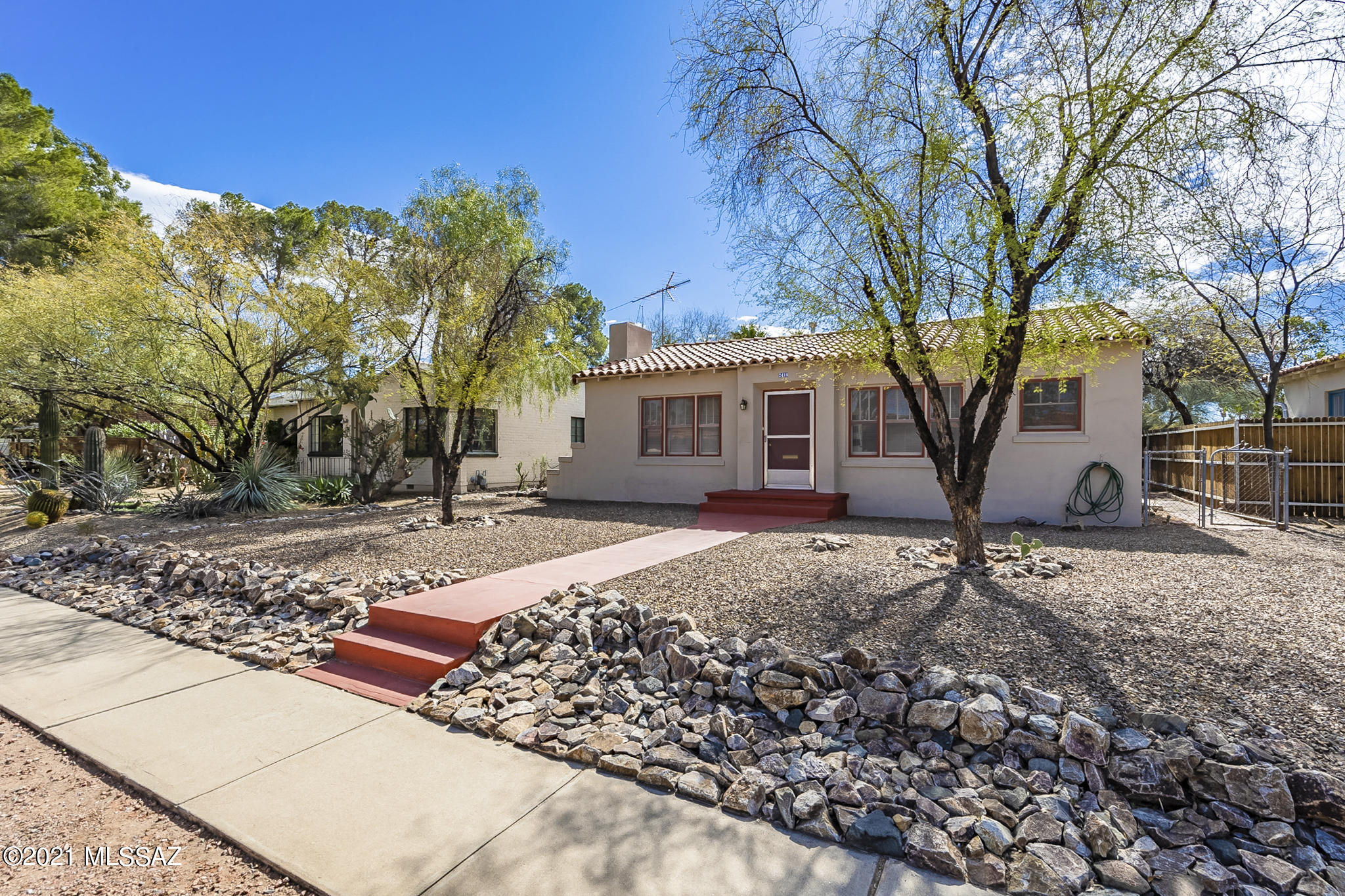 Built 1937. Well maintained historic neighborhood. This charming home features refrigerator and gas stove, ceiling fan, real original wood floors in living room, carpet in bedrooms and AC. Fireplace is (not in use),
Easy to care for yard, front and back, with mature citrus and a Ramada in the back yard. Street parking and parking via the alley with your own private driveway. Washer and dryer in separate laundry room. ALL UTILITIES INCLUDED! Owner is also additionally providing a monthly landscape service! Amazing mid-town location! One small dog or cat $25 per month pet rent. **$28 mandatory enrollment in Resident Benefit Package. Includes HVAC filter delivery, cable internet concierge services, and more! Ask agent for details.** Owner has a Real Estate License.