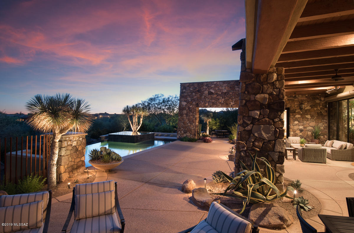 Timeless traditional contemporary in one of Arizona's finest developments, The Stone Canyon Golf Club. Arrive thru the long winding driveway lined with lush landscaping to a natural rock outcropping water fall. Proceed into this exquisitely appointed home including massive exposed wood trusses w/ metal gusset plates. Multiple functional rooms such as den/theater room/office and separate workshop/hobby room. Sliding walls of glass in great room lead to expansive outdoor spaces, infinity edge pool, outdoor kitchen & FP. Control 4 smart home with full A/V capabilities installed. Hardwired inferred heating systems over seating areas. Estate offers tranquil surroundings with the elements of earth, fire, water, incredible mountain and sunset views. Complete privacy and seclusion. This home is fully loaded. Kitchen features 3 dishwashers, Warming drawer, ice maker, trash compactor, subzero refrigerator, gourmet stove and range hood. 750 Bottle Wine Cellar with independent temperature control. Large Laundry Room with oscillating sink for delicates. Remote controlled shade at Living Room stacking glass doors. Upgraded power source for outdoor infrared heating system. Garage has significant built-in storage system. Please see attached list of many features.