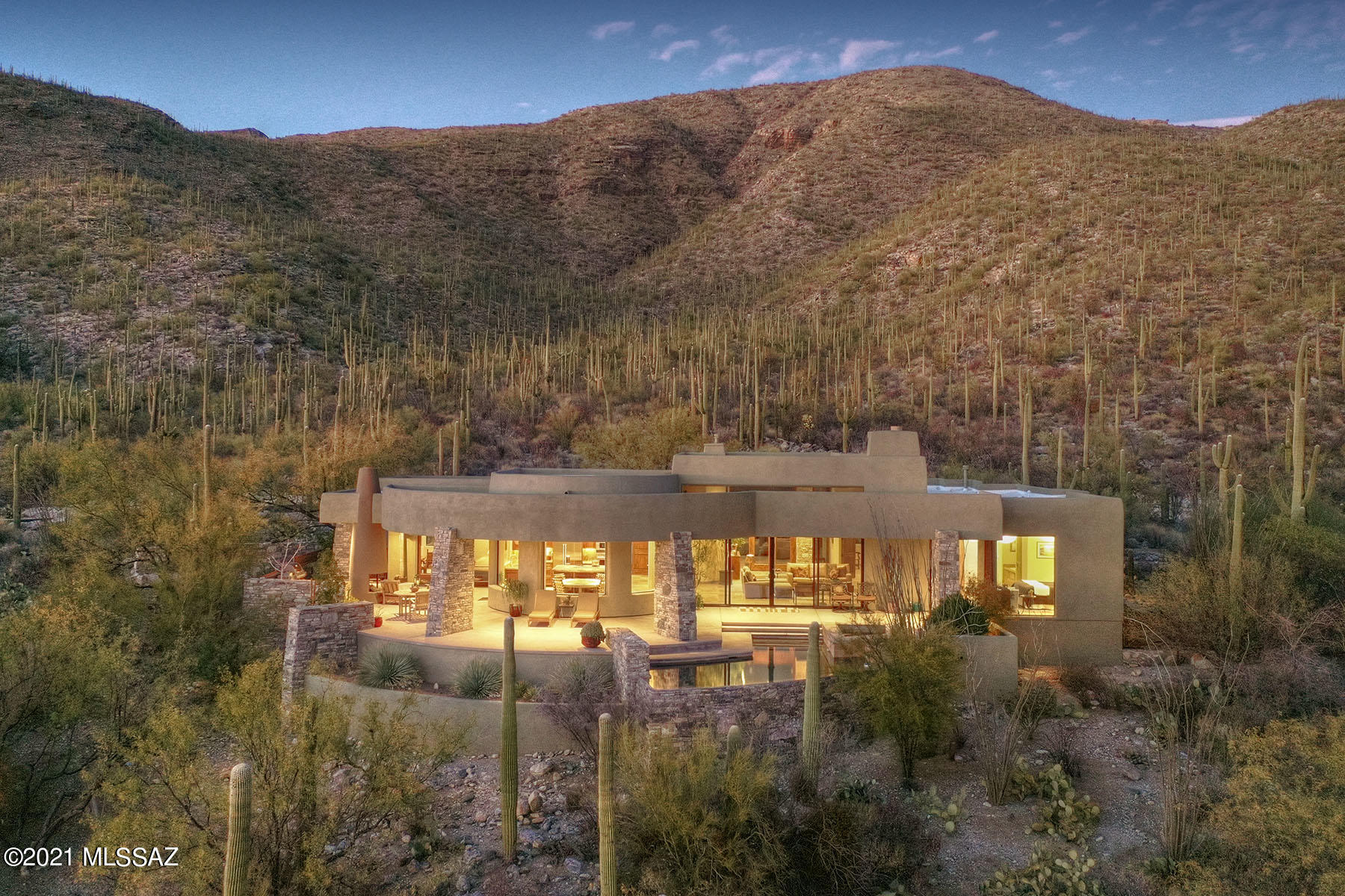 Kevin Howard design overlooking the whole city & sitting above a fairway of the Arizona National Golf Course. Jaw dropping custom touches, graceful curves, knotty alder doors & native stone from the homes foundation used throughout. Well-appointed 40'x26' great room w/ 14ft ceilings featuring 20-foot sliding doors gives you an ideal indoor/outdoor experience. The most discriminating chef will appreciate the kitchen w/ Viking cook top, new Subzero fridge & freezer, custom-made cherry wood cabinets. Amazing views from every room. Resort style flare inside & out w/ negative edge pool & spa, outdoor fireplace, natural gas grill w/ shaded grill area & 1200 sq ft of covered lounging space w/ birds eye view of the golf course. Freshly painted in & out. Modern & Timeless. See MORE tab... Restful owner's suite w/patio entrance & newer electric shade, elegant walk-in closet, custom cherry wood wood cabinets & steam shower. Second bedroom features en-suite bath, walk-in closet & patio door to backyard. The home office/ 3rd bedroom is a perfect combination of luxury & function w/ wood built-ins, semi-circular desk, ample cabinets & bookshelves. 
Every detail uniquely planned w/kitchen electric outlets hidden, monogram microwave & convection oven & under counter lighting. 
Don't forget about the elegant powder room w/ copper sink & stylish 
wallpaper. 
Plenty of parking for guests w/ recently constructed parking spots opposite garage w/new decorative rock wall & 2 roadside parking spots.