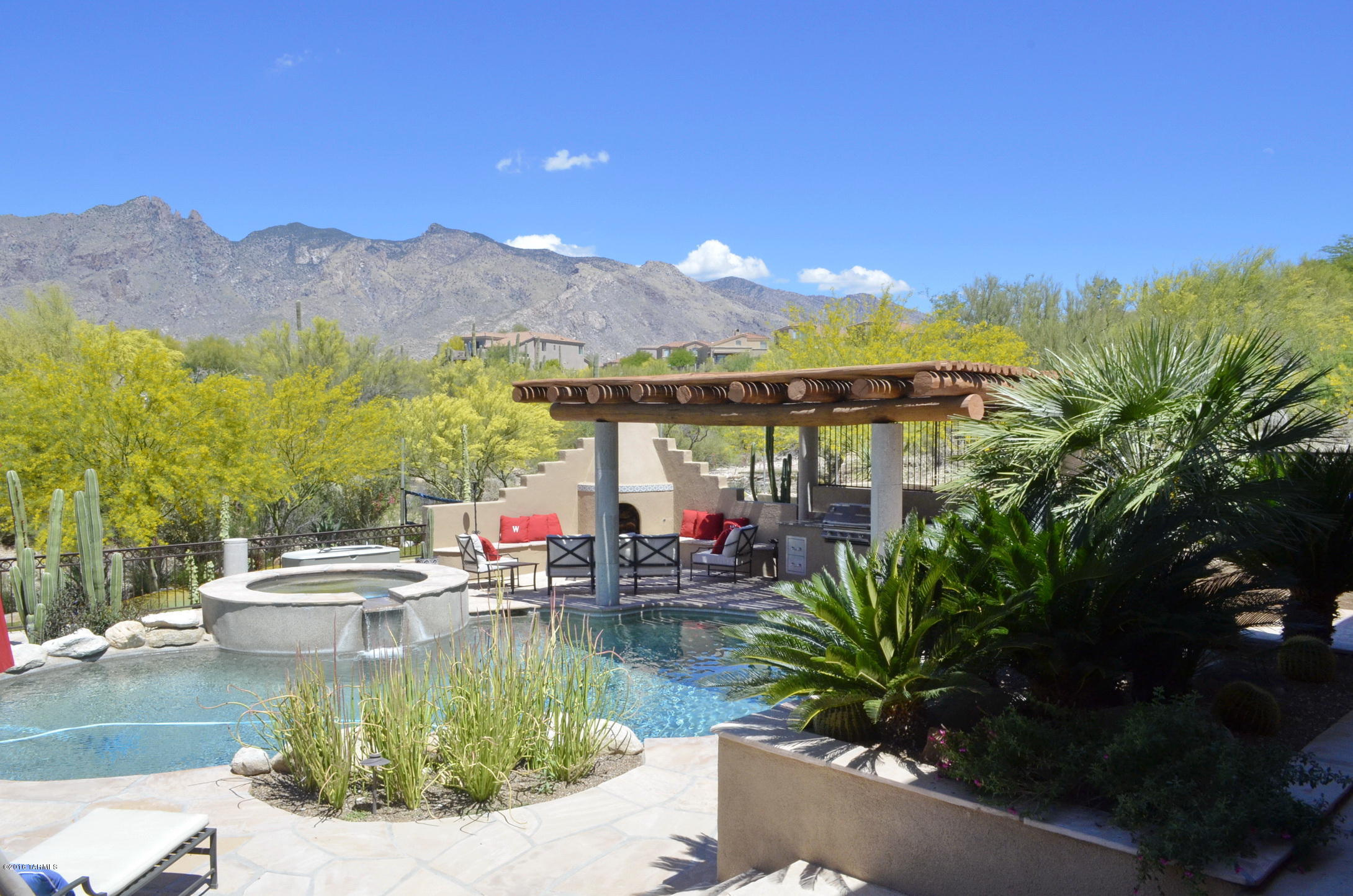 Wonderful soft contemporary home and guest house in terrific La Paloma Estates. Spectacular mountain views flood through over-sized windows. Finger Rock is framed above the lush green of the La Paloma golf course. Chefs kitchen hosts commercial Dacor range, two Dacor ovens and a built-in Subzero refrigerator. Luxurious master suite boasts a steam shower, large walk-in closets,  fireplace and beautiful wood floors. 24'' travertine flooring throughout much of the home. Fabulous rear yard, with terrific pool, spa, putting green, volleyball, amazing spaces for family fun and space for serious entertainers. Home has been impeccably maintained to include fresh exterior paint and recent roof re-coat. This is a great opportunity to own a one of a kind home in an outstanding neighborhood.