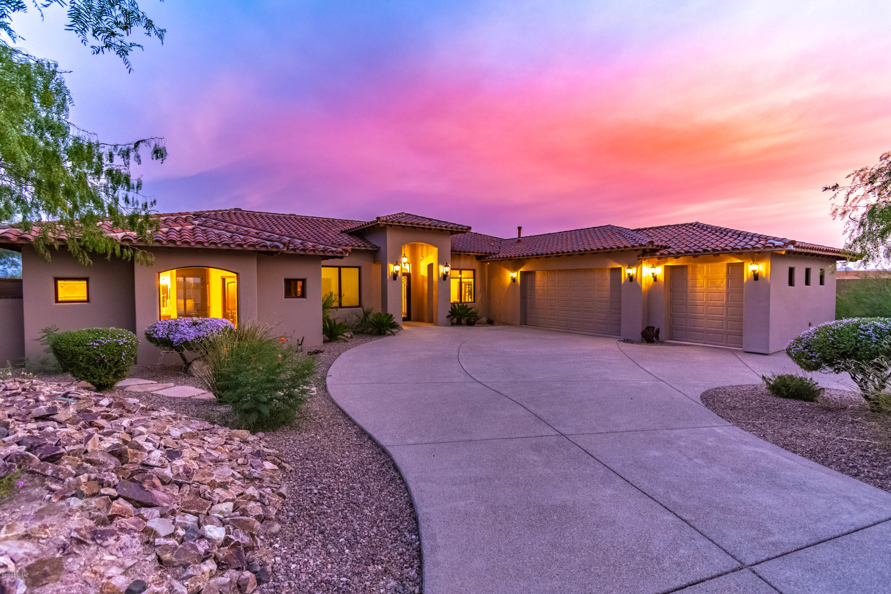Quality built masonry home with spacious floorplan in the convenient, gated Foothills community of Bellas Catalinas features city & mountain views. Freshly painted interiors and all carpet replaced with wood-look flooring. New wrought-iron decorative doors lead you into an inviting living area with a stacked stone fireplace. From there you will pass the formal dining area to arrive at the kitchen with it's ample eat-in area and generous family room space. Tons of windows and an elegant fireplace enhance this great room which is perfect for entertaining. Easy access from there to the pool/spa area adjacent to a full outdoor kitchen. Split bedroom plan has an oversize master and office/4th bed and pool bath on one side, & 2 additional guest rooms on the other.