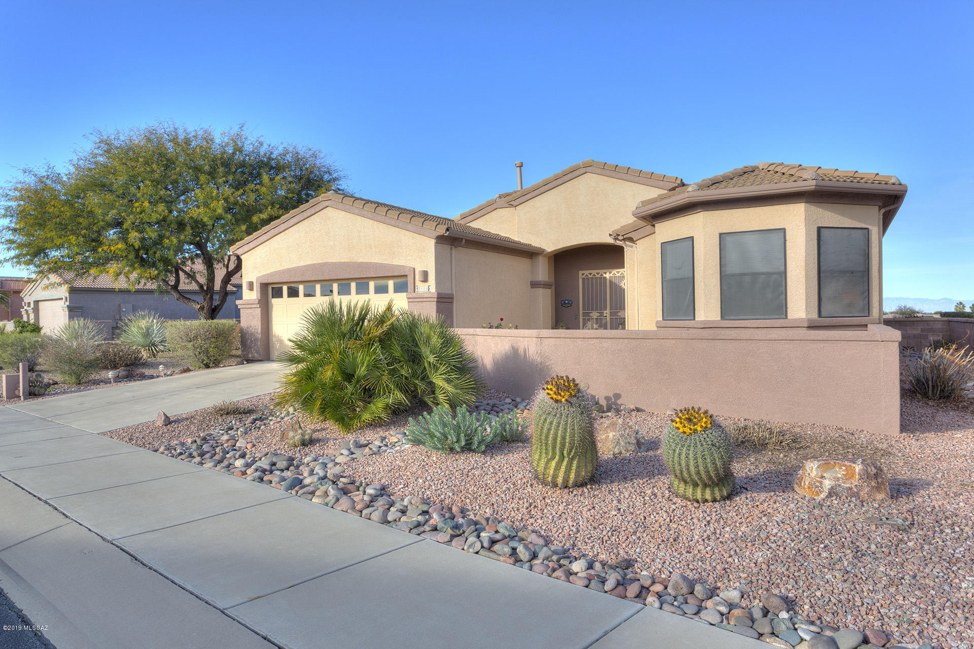 High on the hill...Stunning views front and back! Double entry doors, bring you into a very open floor plan with loads of windows looking out to the desert and mountains. All living spaces are open and all rooms are generous sizes. Lots of tile flooring, loads of storage, two large closets in the master, bay window in bedrm 2, higher ceilings, ceiling fans, designer paint, arches and niches and other features.  Outside a large entry courtyard  and at the backyard  a covered patio, expansive views and plenty of space! A gas stub out for the BBQ and there is gas plumbed at the kitchen range. Super easy living and a fantastic location.