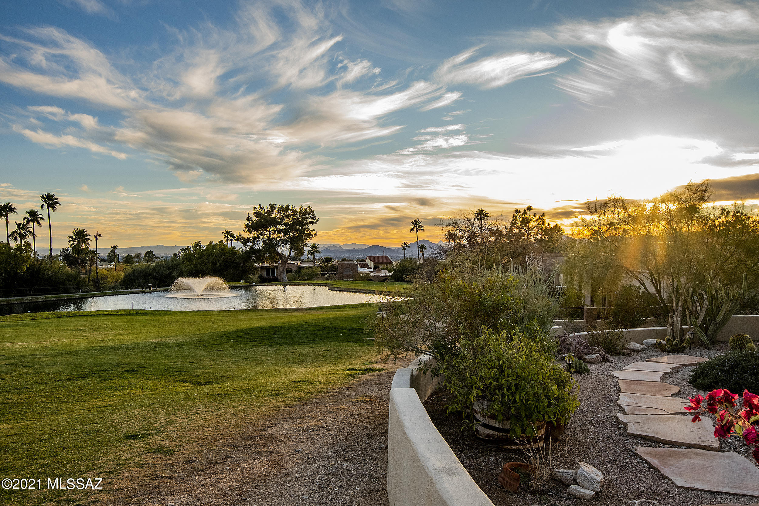 MAGNIFICENT MOUNTAIN VIEWS and GOLF LOVER'S DREAM right on the 7th hole of gated Skyline Country Club, overlooking the peaceful pond! FABULOUS, COMPLETELY REMODELED 3 bedroom MASONRY home with a CONTEMPORARY flair! Chef's kitchen with granite countertops, stainless appliances, amazing gas stove, beverage refrigerator & island with breakfast bar. Lovely, warm bamboo wood & neutral ceramic tile floors. Beehive fireplace with granite surround. Nicely remodeled bathrooms, all new windows & doors. Huge master closet & all closets w/ excellent built-ins. Expansive covered patio w/ built-in BBQ, to use while enjoying the LUSH greens and serene setting. Low care yard to just sit and relax...Truly the MOST PERFECT spot in all of Tucson! IMMACULATE! PHENOMENAL VIEWS & LOCATION! Can't be beat! HURRY!