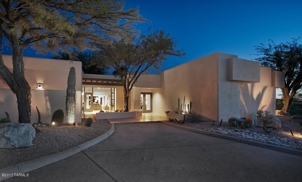 Situated on a private hilltop in gated Catalina Foothills 10, this contemporary Tyson home features stunning city and mountain views to be enjoyed from indoors or from the numerous patios and spectacular outdoor living areas. Newly remodeled kitchen, formal and informal living areas with cozy fireplaces, formal dining room, and a built-in grill convenient to kitchen and patio dining make this the perfect home for entertaining! Master suite offers luxury and comfort with a private patio, dual fireplace, walk-in-closet and newly remodeled bathroom complete with dual vanities,soaking tub and walk-in shower. 2 more family bedrooms and baths, an office, plus charming guest quarters featuring a private entry, sitting area, kitchenette, and patio overlooking the pool and city views- a must see!