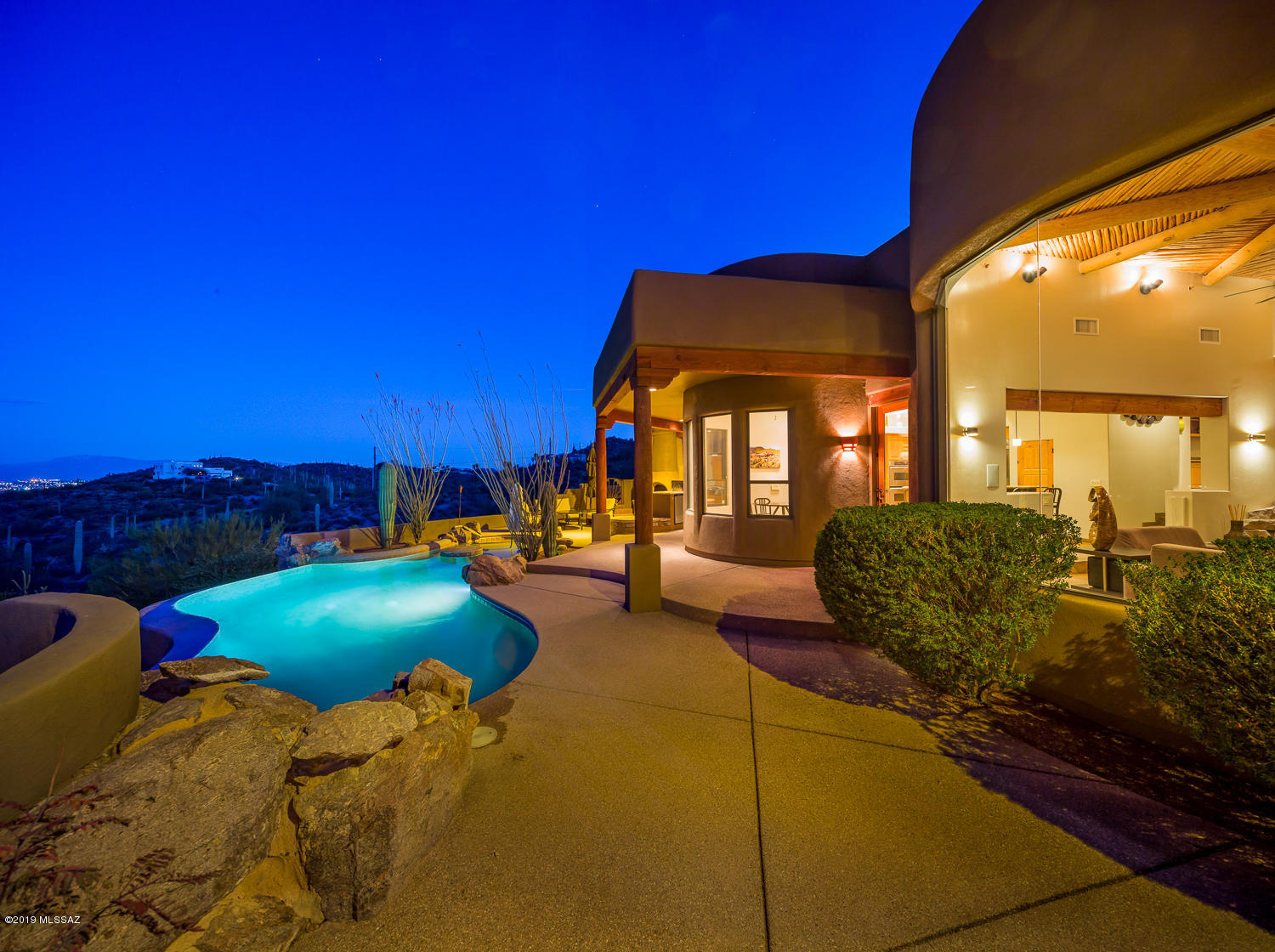 Top of the world views from this west side mountain retreat! From the moment you walk though the custom wrought iron & glass front entry you will be amazed by views of the entire Tucson valley. Walls of windows showcase the city lights & mountain vistas for miles. This dream home includes a heated pool, multiple areas for luxurious relaxation, outdoor fire place & more. Make sure you check out the RV garage complete with an entertainer's dream area, including a high tech media room, bar area, shuffle board table, auto lift & more. This is a must see home!