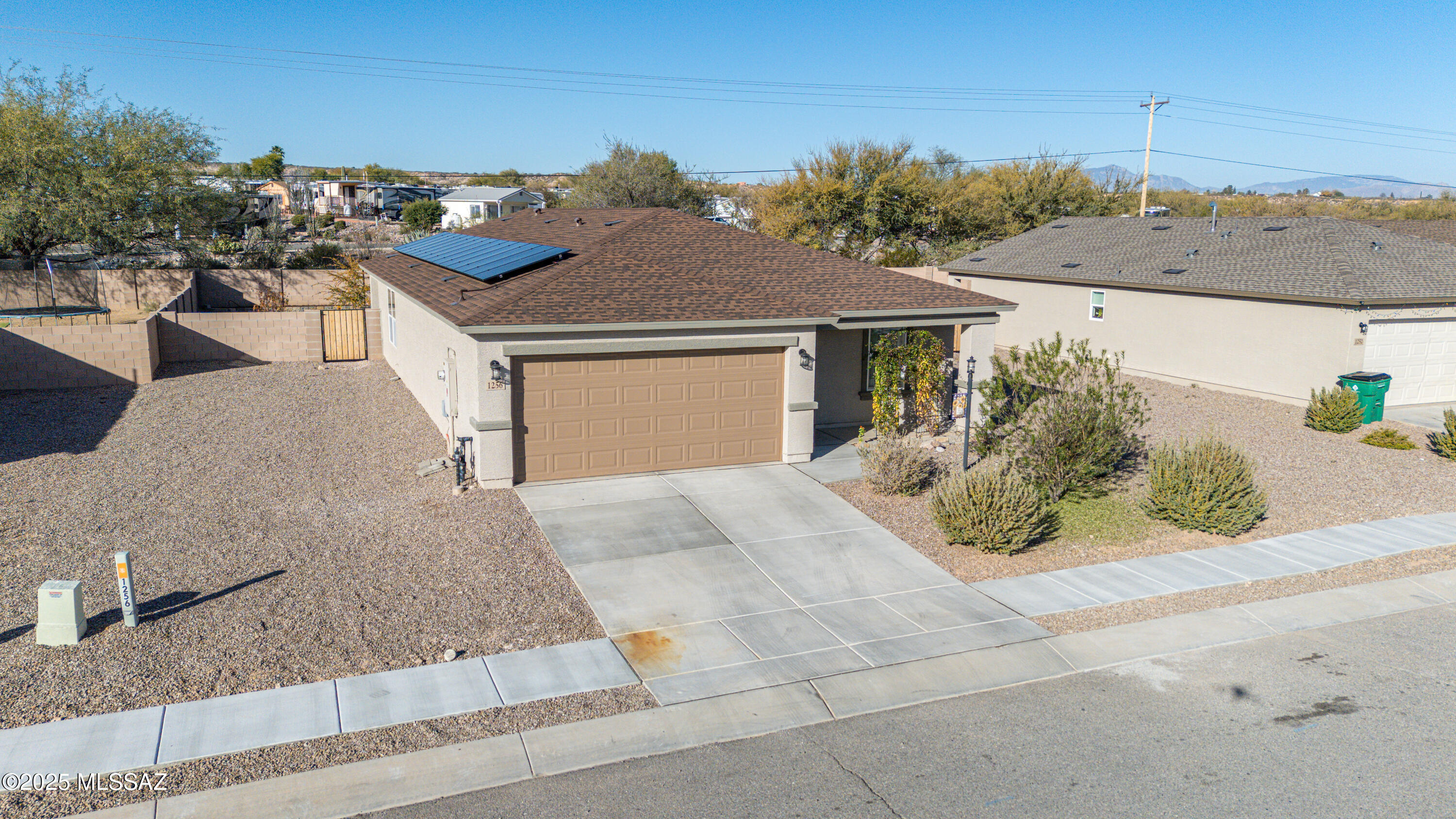 Nearly new 3 bedroom 2 bathroom home with beautiful granite throughout. The backyard is nicely landscaped with artificial grass,  trees, flower beds, garden areas and fully fenced or privacy. Open Great Room, kitchen has stainless steel appliances, pantry and a large laundry room right off the kitchen. Solar is less than a year old.