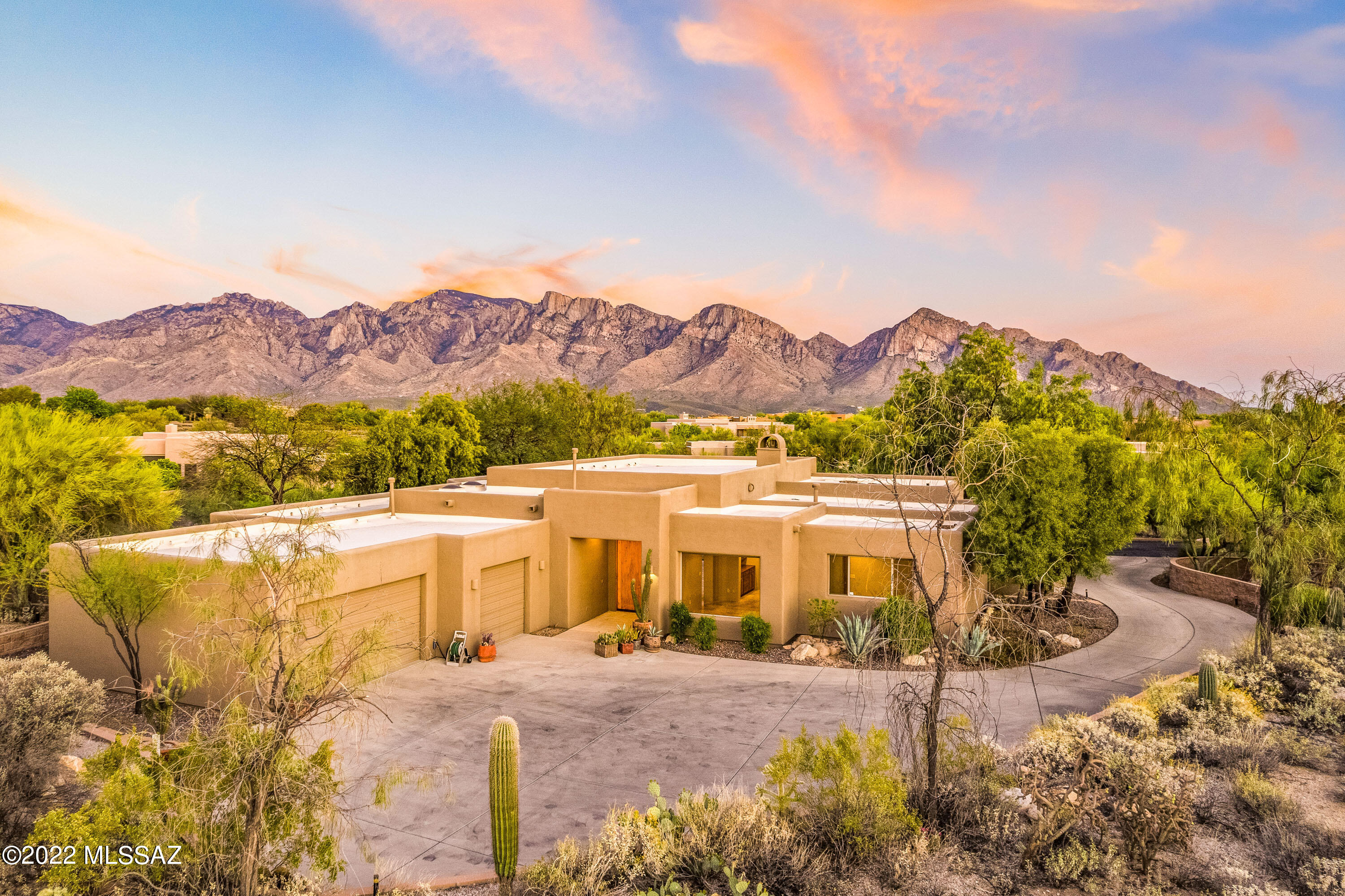 Extensive Catalina Mountain views are yours to enjoy from inside and out with this delightful great room style 3K SF home with fireplace, Travertine floors, and big windows plus 3 Bedrooms, 3 Baths, Rec Rm (alt Formal Dining Rm), Office & 3-car garage. Gated Coyote Ridge community in Oro Valley close to everything yet private and serene location with pool and spa. Elevated site offers privacy with marvelous SE-facing views! Great room design provides open space for relaxing or entertaining. Double sliding door to patio allows indoor/outdoor enjoyment. Spacious master suite includes bath with large walk-in shower. You'll LOVE the views, layout and amenities of this well-maintained home including transferable roof warranty and 2013 mechanicals. Perfect for your  AZ relaxation lifestyle!