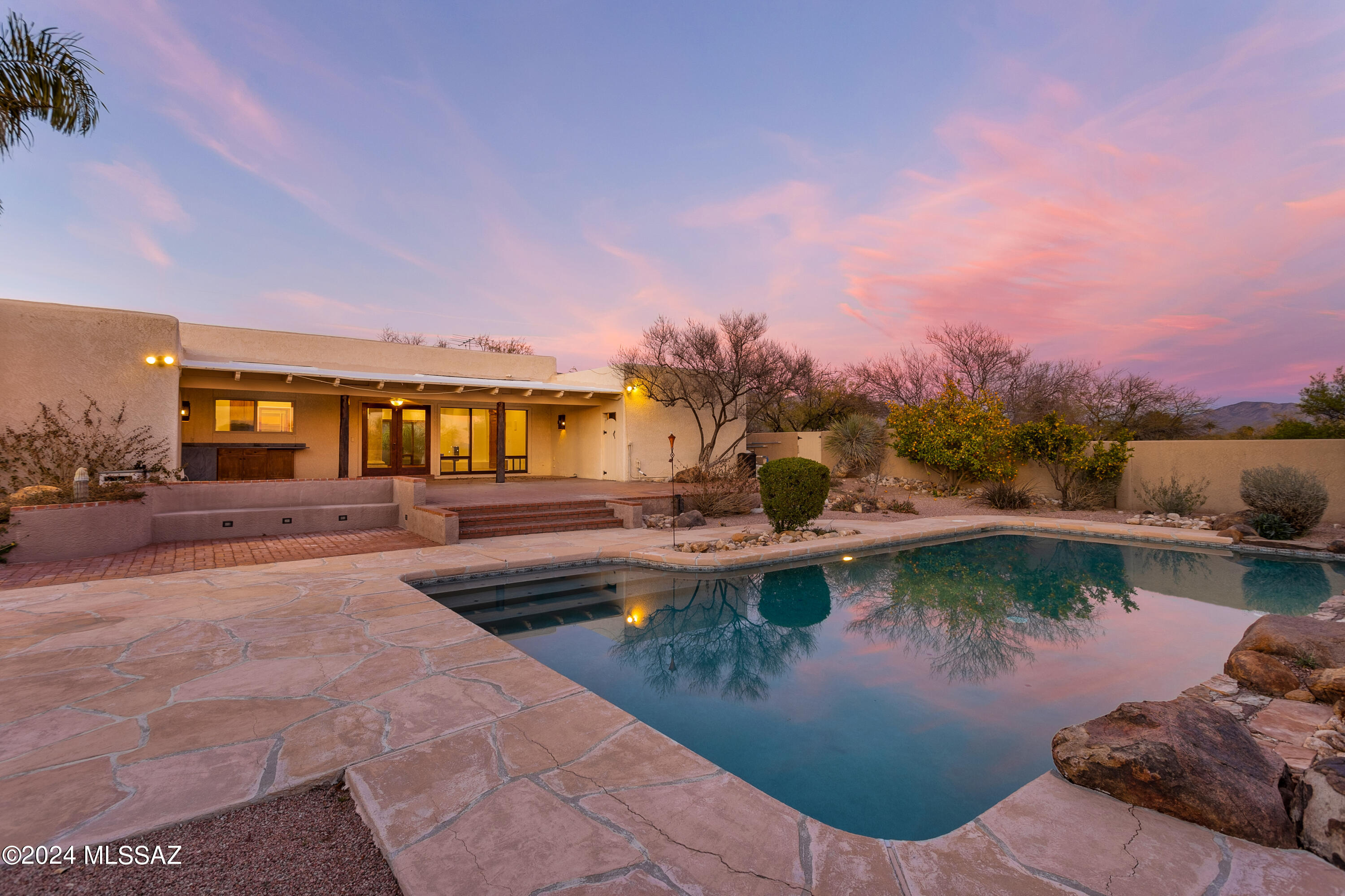 Sprawling one-level Sabino Vista custom home on an elevated 1.2-acre  corner lot w/ sensational city, mountain & sunset views. Perfect multi-genertational  home  Circular driveway lined w/ pavers. Charming courtyard entry. Huge great room w/ FP has a lavishly finished open kitchen w/ center island & breakfast bar. Extensive ceiling lighting & skylights brighten the space. The kitchen area flows to the deep covered patio w/ an outdoor kitchen area & a massive backyard w/ a heated pool & soccer field-sized artificial turf area. Very private backyard has exceptional views of the city & sunsets. Dynamic split bedroom floor plan features a guest suite with separate entrance, a master suite wing w/a separate office & ex. room, walk-in closets, sink vanities & spa area