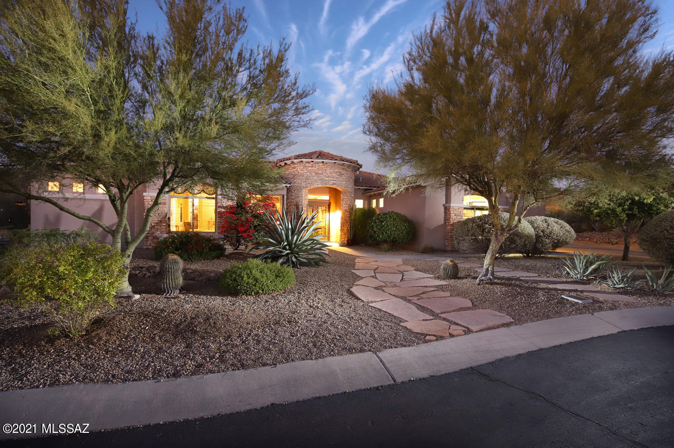 Elegant contemporary home located in popular Dos Lagos at Dove Mountain.  Enjoy Tortolita mountain views as you walk in through the big picture windows in the living room.  Spacious & open floorplan features huge kitchen that opens to living & great room. Outdoor living at its best includes pool, spa, firepit, built-in bbq, putting green and big covered patio. Kitchen features granite, island, double ovens, huge pantry and breakfast bar seating plus breakfast nook.  Big owner's suite features views, patio access, 2 big walk-in closets and luxurious bathroom with garden tub & separate shower.  Den/office provides custom built-ins.  Split bedroom plan features two spacious guest bedrooms, both with ensuite private bathrooms. 3 car garage & huge laundry with storage space.