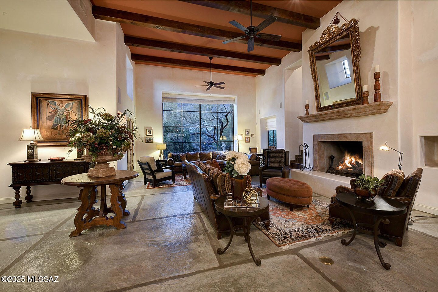 A timeless Spanish Colonial Masterpiece with unmatched city and mountain views.
Located on a quiet cul-de-sac near the top of Alvernon way and nestled in the coveted Catalina Foothills, this meticulously crafted 4-bedroom, 4-bathroom home spans 4,025 square feet of luxurious living space on an expansive 0.88-acre lot. 
With sweeping Catalina Mtn, Finger Rock and Tucson city views, every detail has been thoughtfully updated, masterfully blending timeless Spanish Colonial charm with contemporary sophistication.  Enter through a grand front courtyard, complete with a tranquil fountain, and pass through the impressive 11' historic mesquite hacienda door, imported from Mexico. Inside, you'll be welcomed by a magnificent great room featuring soaring 16' ceilings, a ornate wrought iron chandelier, beautiful faux stone flooring, and handmade steel windows & doors. The walls are adorned with refined imperial plaster, creating an ambiance of warmth and elegance.  This home has undergone a stunning transformation, with significant upgrades throughout. The chef's kitchen, fully redesigned in 2022, boasts top-tier finishes and modern appliances, while the bathrooms have all been completely remodeled. The laundry room has also been updated for added convenience. The luxurious primary suite, remodeled in 2022, offers a serene retreat with Venetian plaster walls in the bedroom and a custom California Closet.  Rustic Manganese Saltillo tile, installed throughout the bedrooms, primary bathroom, and closet, adds a touch of natural elegance that complements the home's overall aesthetic.  Step outside to enjoy the exceptional Tucson weather in your expansive backyard. The outdoor space includes a sports court, lush artificial grass (2021), two oversized concrete vegetable garden planters, and a brand-new BBQ (2022), perfect for entertaining and outdoor cooking. The pool area has also been updated with a new pool pump (2020) and sand filter (2021), ensuring a pristine swimming experience year-round.  This home features a range of updates for optimal comfort and convenience, including a tankless water heater (2019) on the east side, new AC/furnace units (2018) on the east side, and newly installed water heaters (2024) and AC/furnace units (2024) on the west side. A central vacuum system (2023) enhances daily living with ease.  Located in the prestigious Catalina Foothills, this home offers unmatched proximity to top-rated schools, shopping, dining, and all that Tucson has to offer. With its expansive lot, exceptional updates, and flawless attention to detail,  this residence stands as a true masterpiece.