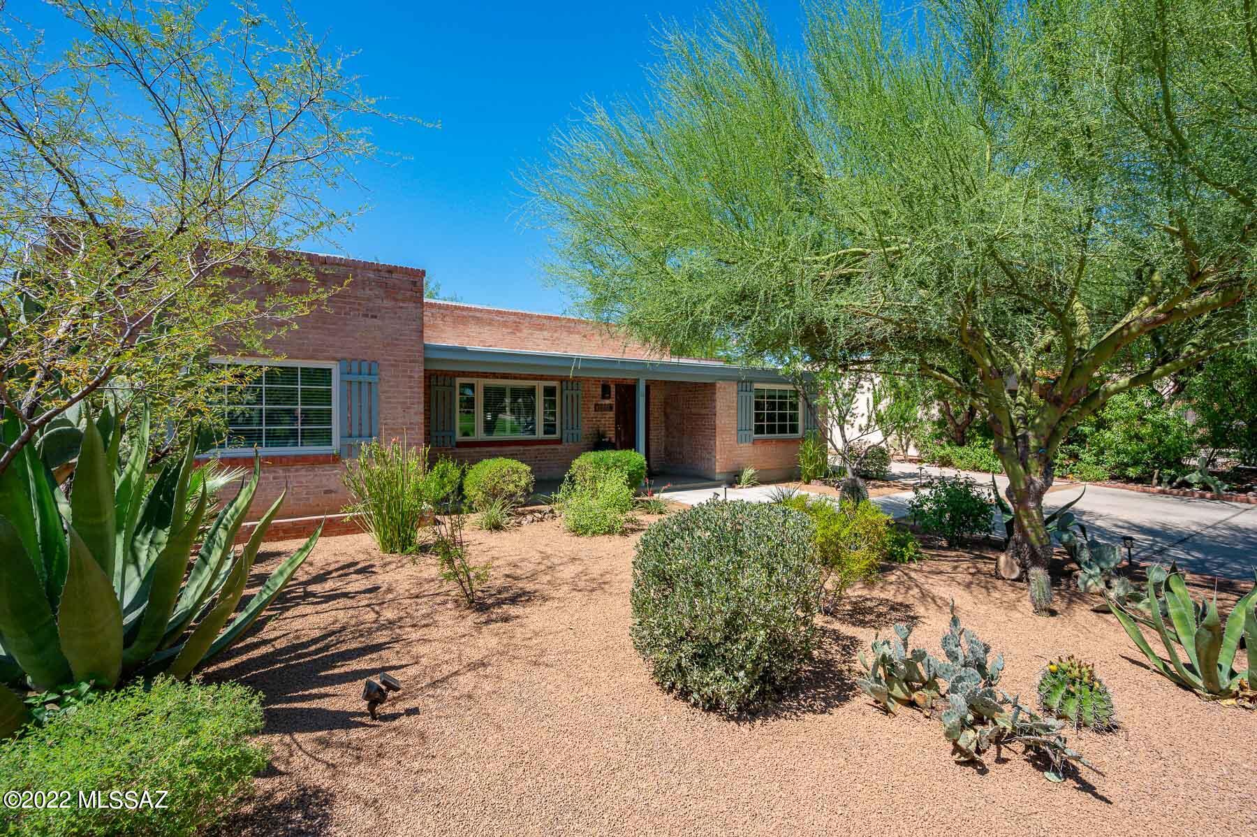 Amazing Hacienda in Historic Catalina Vista- prime location, just minutes to U of A / Banner complex.  Updated throughout with quality and function in mind, this is a great entertaining home!  Kitchen opens to large family room area with soaring ceiling and grand corner fireplace,  filled with great natural light.  Flexible floorplan with multiple living & dining areas is a desirable split bedroom design.  Chef's kitchen features granite countertops and stainless steel appliances.  You will love the wrap around rear courtyard that opens to the pool area.  Extensive custom landscape with sail shade ramadas, custom metal fence + gates, planters & fountain.  Gorgeous plantings, including citrus trees & pomegranate, and no matter the time of year there is always something in bloom to see... Wonderful Tahoe Park is across the street extends the natural setting of the house, features a new play area, mature shade trees and is just a lovely well kept park you can see from the front porch.  Front yard is easy care with lovely desert landscape and mature trees.  Nice amount of off street parking will accommodate 4 cars.  So many custom extras in this home, you must see to appreciate!