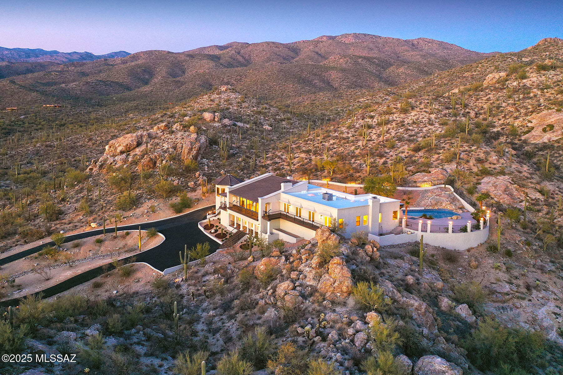 Panoramic views of mtn, city & Tanque Verde valley beckon through walls of windows adorning this luxurious home beautifully set on 7.22 hillside acres in the heart of La Cebadilla Estates. Gleaming pecan wood floors, etched marble FP, fabulous kitchen with 48-inch dual fuel range, double ovens, 2 DW, separate column refrigerator/freezer, oversized island w/bar seating, solid wood cabinets & casual dining w/jaw-dropping views. Full remodel also included luxe baths throughout; split plan offers romantic owner's suite w/FP, city lights & ''wow'' spa-like bath w/soaking tub & pool access; the lower level is great entertaining or kid hang-out space w/exercise rm, wet bar, potential media room.All new  exterior decking in front & bath for 2053 covered outdoor living enjoyment. See floor plan!