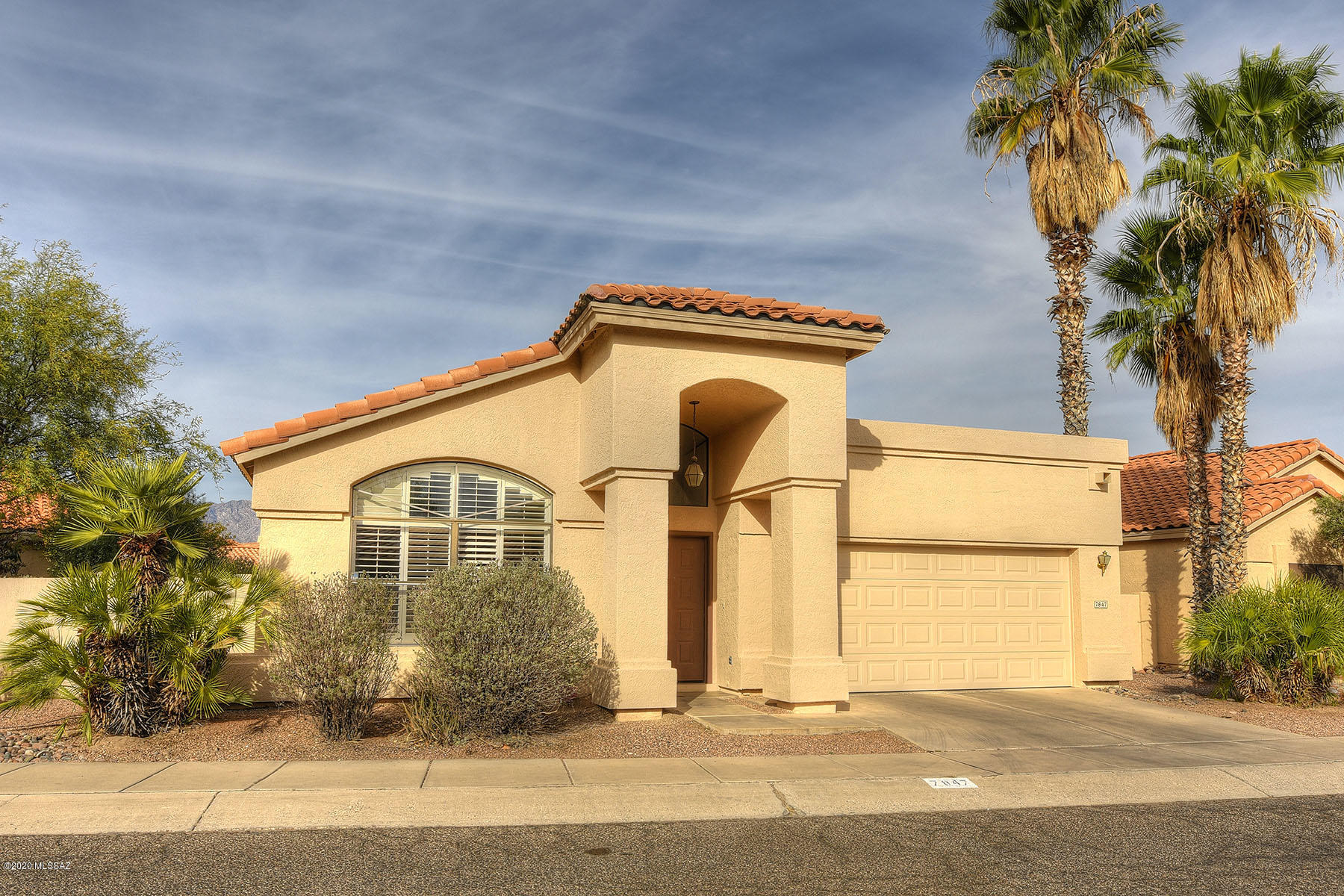 Pretty Property in the heart of Sought after ''The Enclave'' Adjacent to the River Walk at Tanque Verde and Pantano-Tile and Wood (Bamboo) Floors in most of the house-Nice Carpet in Each Bedroom. One level-NO Steps-Walled Back Yard-Spacious Owner Suite has an ample Closet-Newer Jetted Soaking Tub with Neat Shower Head, too.  High Ceilings, Shutters, Designer Interior Paint-Wall of Book Shelves in Great Room-Kitchen has large Dine-In Space and Island-Deep Double S/s Sink-Exterior was just Painted!