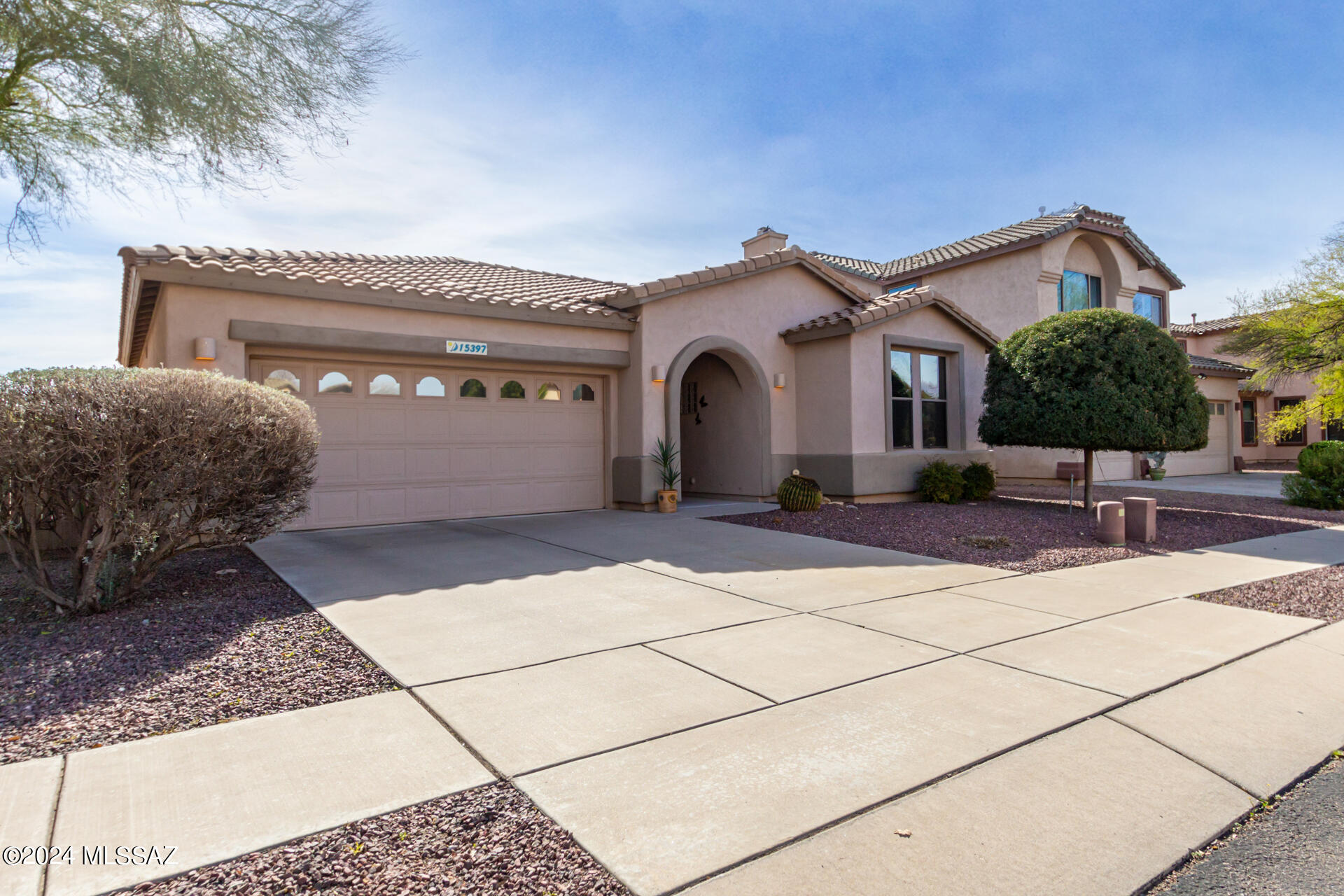 Welcome to the gated, Lakeside neighborhood of Agua Azul located in the award winning community Rancho Sahuarita! Impeccably maintained by its original owner, this stunning single-story home boasts hardwood flooring, a soft, neutral color palette, and newer stainless steel appliances. Enjoy the convenience of the Sahuarita lake,  clubhouse, fitness center, multiple walking/bike riding trails, dog park, and tennis courts nearby. The solar panels ensure energy efficiency, keeping cooling costs low, with a lease not to exceed $100 per month! The private fully landscaped backyard has no back neighbors and gorgeous mountain views to enjoy year around in Arizona. Cont... This well kept home also features an air purification system, water softener  and a spacious primary suite with a soaking tub and closet organization system! Don't miss the opportunity to call this immaculate property home.