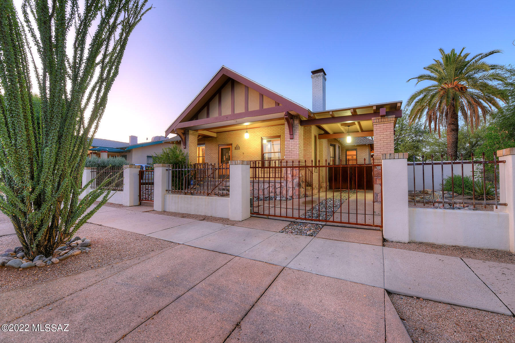 This stunningly remodeled 1913 bungalow (historic records show construction year between 1905 & 1913) in the popular West University neighborhood is listed on the National Register of Historic Places as a contributor to the West University District. Originally the home of Anna Jacobus, wife of 1910-1911 Tucson mayor Preston N. Jacobus. Both the 2,854 sq. ft. 5-bedroom main house (399 sq. ft. finished basement could be 5th bedroom/office/exercise room) and the 445 sq. ft. detached guest house have been lovingly remodeled & updated without interrupting the original quality & character. Highlights include a covered, wraparound porch, a living room with a fireplace, original hardwood flooring, high ceilings, and an abundance of windows. The formal 12' x 17' dining room has the original plate