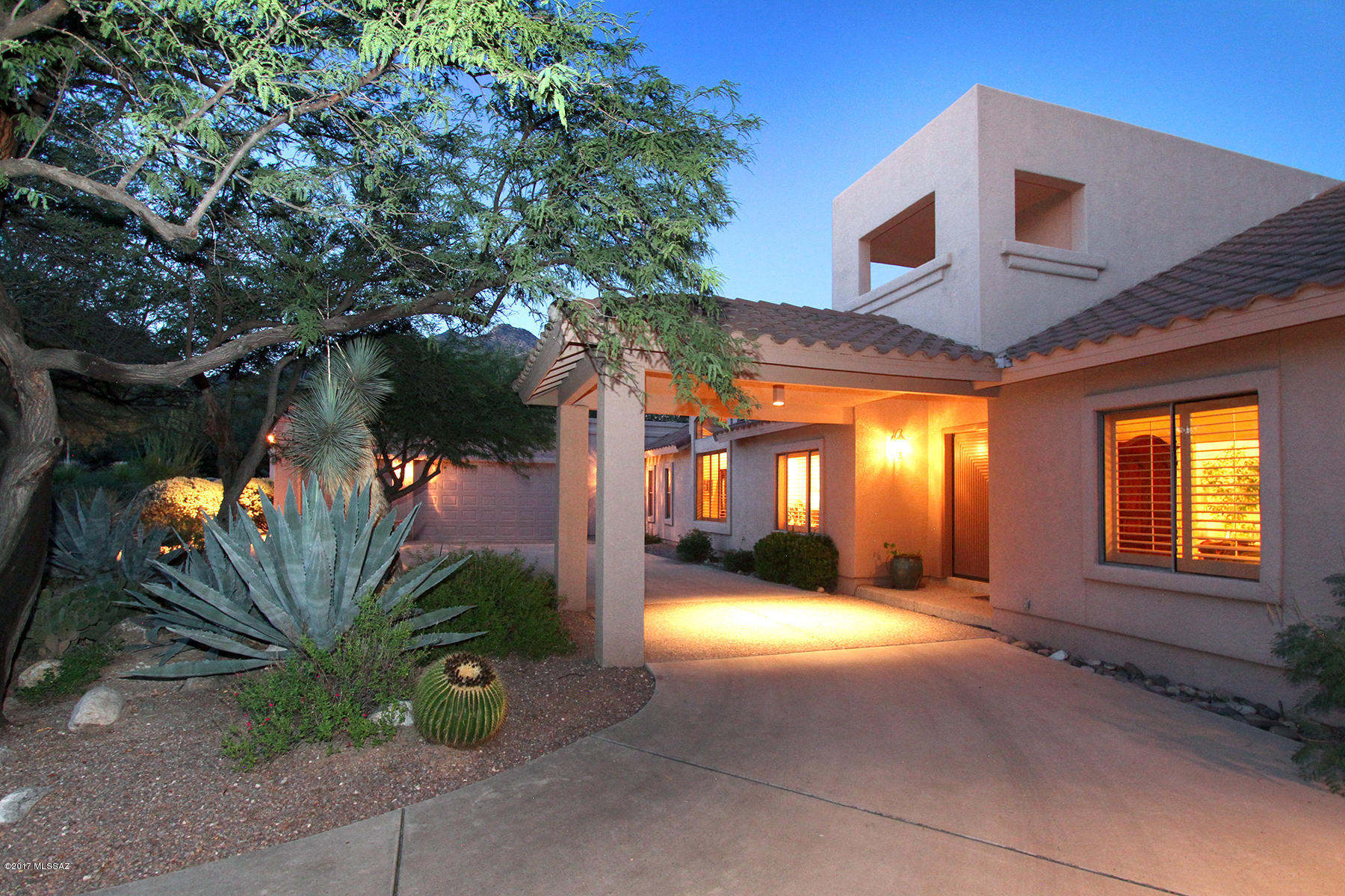 Located in prestigious, gated Ventana Canyon Estates on a quiet cul-de-sac, this home features a circular drive and portico entry.  This home features dramatic high ceilings, neutral porcelain floors, plantation shutters and recently updated kitchen with custom cabinetry, quartz counters, new SS GE Café appliances & induction cooktop. Cozy family room w/ beehive fireplace is off kitchen.  Enter inviting master suite with double entry doors adjacent to den, large walk-in closet and upgraded bath with tile accents makes this a wonderful retreat.  Den or study would be an easy conversion to a 4th bedroom.  Relax in spacious back yard with extended covered patio, artificial turf, sparkling pool, pool bath and lush landscaping with mature trees and mountain views.
