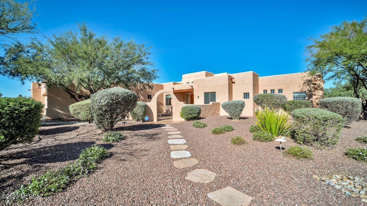 This exceptional property offers the perfect blend of comfort & convenience. Boasting a 3-car garage and freedom from HOA restrictions.  The generous walled, low-maintenance landscaped yard frames a peek of the Catalina mountains. Nestled within a small, intimate community. This residence is designed with a split plan for functionality. The kitchen has an island, granite counters & customized cabinets with 10 pullouts.  Its solid masonry construction, with extra insulation on the west wall, ensures energy efficiency. Step inside to be welcomed by soaring ceilings and an abundance of natural light from north-facing windows. The property also offers a leased solar system which equals low TEP bills. Moreover, this home's location offers easy access to shopping, restaurants and NW Hospital.