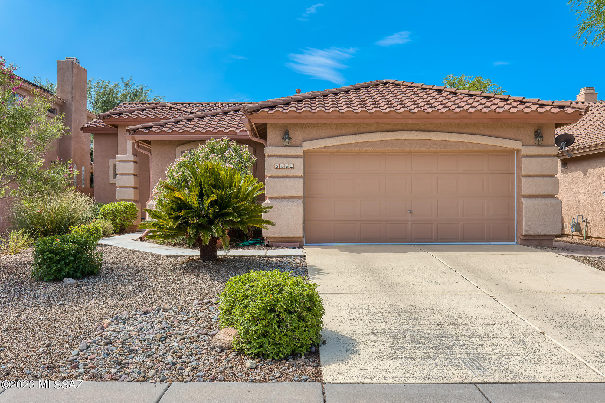 Welcome to this charming 2 bedroom + den, 2 full bathroom, 1711 sq ft home in the desirable Rancho Vistoso community. Located in the heart of Oro Valley, this home sits at the end of a quiet street with lush, maintained front landscape. As you enter through the foyer, you'll enjoy neutral porcelain, wood look tile throughout the home. (No carpet!) A split floor plan with the primary bedroom and en suite bathroom to the left and the den and guest bedroom, with bathroom access from the bedroom, to the right. The open floor plan features a great room, dining area, spacious kitchen with ample cabinets and a breakfast bar. Tall ceilings with crown molding detail, a built in entertainment center, and large windows with custom light filtering dual shades that allow for natural light to filter in An oversized sliding glass back door opens to a gorgeous backyard with fruit trees (orange, grapefruit and lemon) flagstone pathway, rock feature and mature landscape with mountain views. Also, an above ground pool. Located within minutes of Oro Valley Marketplace, Oro Valley Hospital and medical center, restaurants, grocery shopping, gas stations and more!