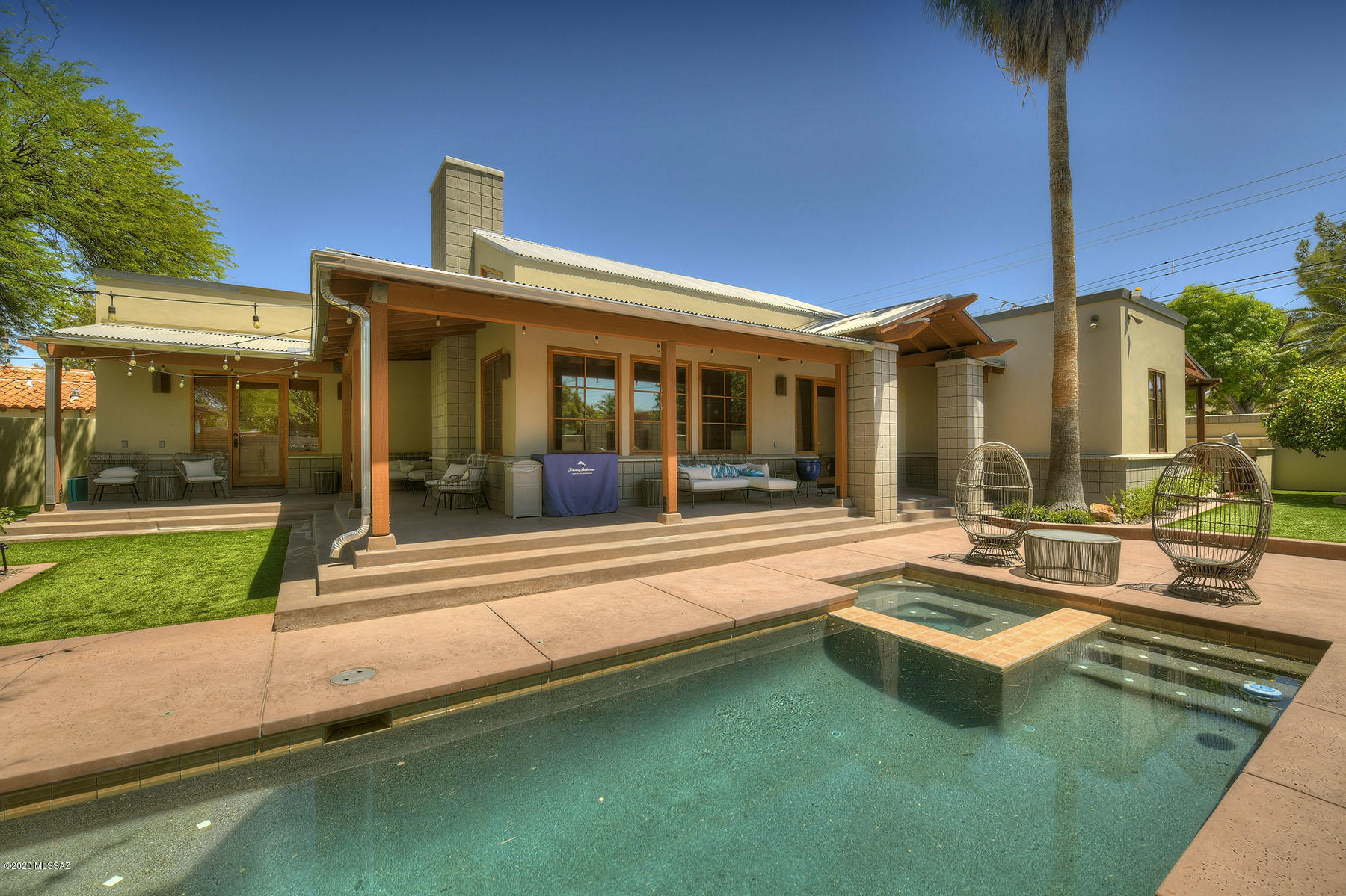 One-of-a-kind 2001 contemporary in the historic Arizona Inn neighborhood and one block east of Banner University Hospital.  Built with exceptional quality, craftsmanship and detail, open the gate into your fully walled, private mid-town sanctuary with wrap around porches, pool and spa, 3-bedroom 2,038 main house and 362 sq. ft. guest house.  Enter into main house to see soaring cathedral open beamed ceiling, fireplace, and African teak wood floor.  Gourmet kitchen features granite counters, stainless steel appliances, center-island with breakfast bar, custom cherry wood cabinetry and polished concrete.  Wood frame windows, custom window coverings, guest house your guests won't want to leave, and so much more.  Walk or bike to the Arizona Inn, U of A, shopping and restaurants.
