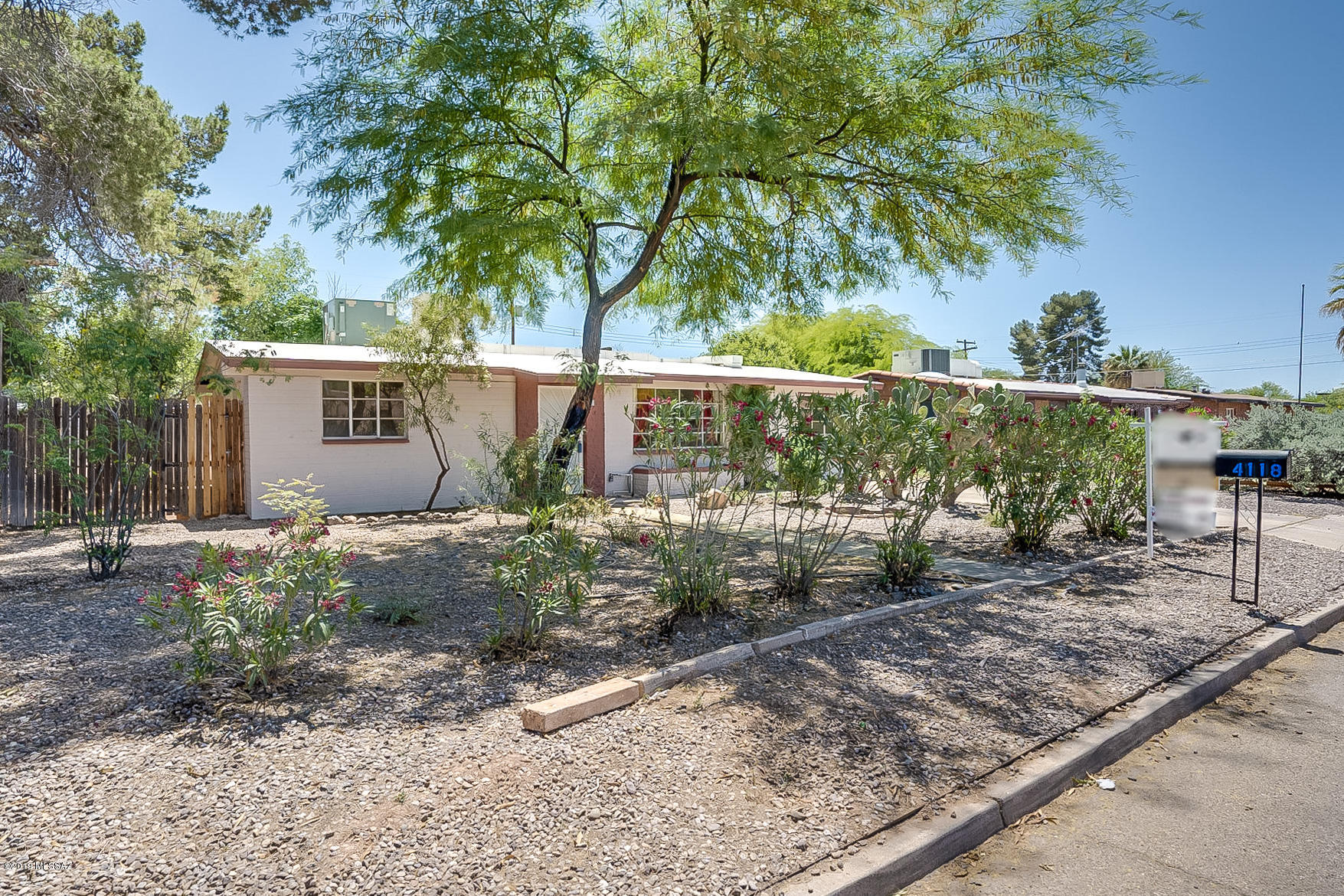 MOVE IN READY central 3bed/2ba charmer. Gorgeous CERAMIC TILE THROUGHOUT HOME, no carpeting or popcorn. FRESHLY PAINTED INSIDE AND OUT, roof work done 2018 (2 year warranty). Custom SOLID WOOD KNOTTY ALDER CABINETS in kitchen, DETAILED TILE WORK, GAS RANGE and newer dishwasher. Enjoy the PRIVATE, LANDSCAPED BACKYARD from the LARGE COVERED PATIO. Close to TMC, shopping, restaurants.  Just a quick jaunt to the ''Loop'', a 131 mile bike/walking path that follows the banks of the Tucson riverbeds. QUALIFIES FOR PATHWAY TO PURCHASE. Agent/owner. Owner is licensed to sell real estate in the state of AZ..
