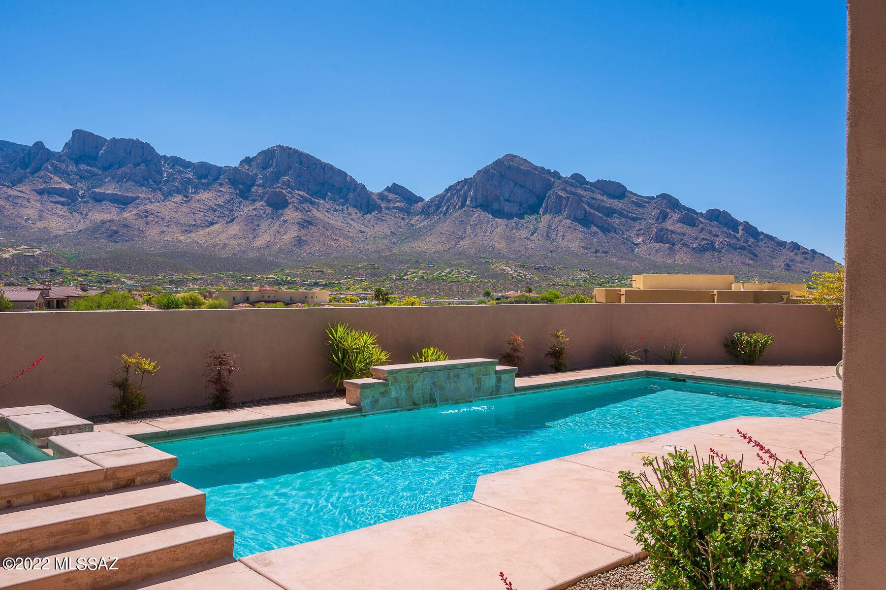 Imagine walking into a newer contemporary home and seeing a stunning vista of only the Catalina Mountains. This lovely Sombra built home sits high with only one neighbor to the side. Large open great room with a kitchen almost the same size which flows out to the East facing patio.  3 Bedrooms each has a full bath, office plus a bonus room. You can enjoy relaxing every evening watching the brilliant colors and shadows while enjoying music on your patio. The third car bay was converted at construction into a fully incorporated work out room which could have many uses. The guest bedroom has a lovely ensuite bath. This home has been maintained in every way; new exterior paint, new carpet and nice side area of artificial turf for pets or play equipment. Newer construction and no waiting!