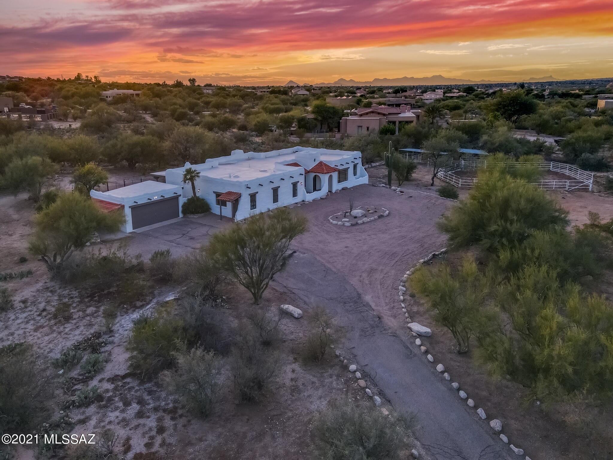Stunning Tanque Verde Ranch Estate! Nestled on a secluded, elevated, and quaint lot this beautiful home is ready for its new owners! Get a true feeling of privacy, amazing views, modern updates, and country living all in one. As you make your way through the front door you're welcomed with a high ceiling foyer ornamented with a beautiful Monrovian touch that invites you through the bright split floor plan that is sure to accommodate and impress all of your family and guests with its unique and tasteful finishes promoting a luxury yet cozy home. In the heart of east Tucson, you are conveniently located by everything that the Tanque Verde area has to offer. Walk this property at any time of the day and it surely lives up to its wow factor! Come make this home yours before its gone!