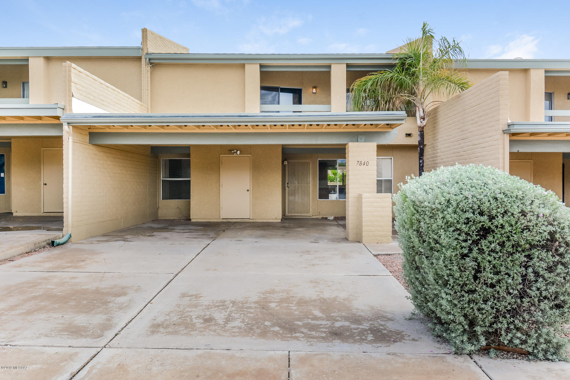This Tuscon two-story home offers vaulted ceilings, a wood-burning fireplace, a balcony, and a two-car carport.
