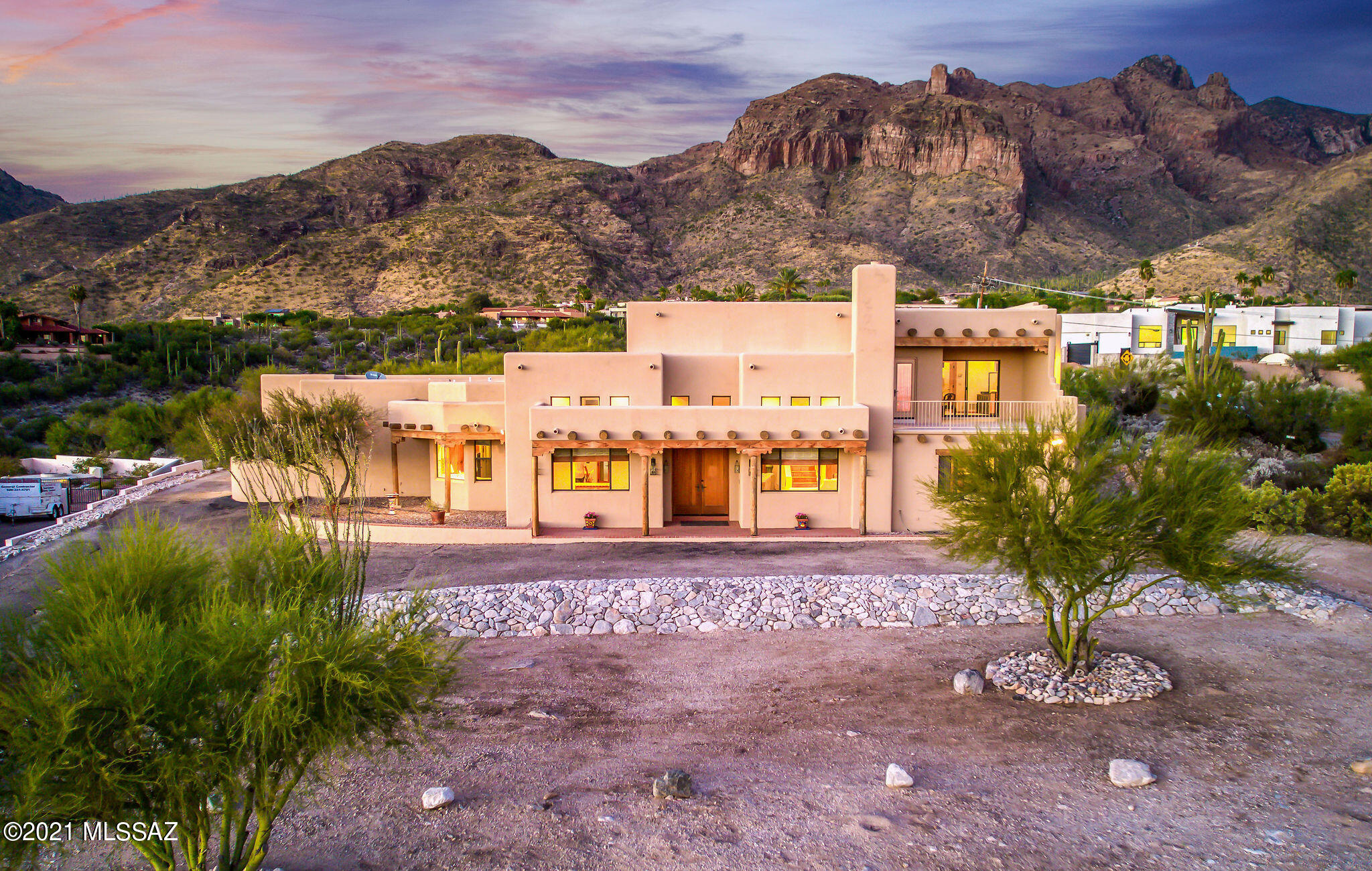 Enjoy some of the best views the Old Pueblo has to offer perched on top of Campbell Lookout! Fantastic opportunity for custom built all electric 3,527 SqFt split floorplan 4 bed/4bath Southwestern masonry stucco Santa Fe including oversized finished attached 1,452 SqFt 3 car garage (RV sized 3rd stall) on premium 1.17 acre corner lot, no HOA, RV parking in desirable Las Vistas Encantadas in North Tucson. N/S orientation provide sky piercing panoramic mountain views and stunning 180° city views! Outstanding location walking distance to Campbell trailhead, Manzanita Elementary school, minutes from La Encantada luxury shopping and restaurants in vaunted Catalina Foothills School District. Custom built in 1992 by 3X luxury custom builder of the year Michael Wachs Construction combining energy efficiency (averaging $165 summer electric bill/$75 winter) with authentic southwest details including: Soaring cathedral wood beamed, wood plank ceilings, rough cut Vega beams, Saltillo flooring, Talavera Spanish glazed tile counters, backsplashes and accents, genuine solid wood internal doors, trim and baseboards throughout, Southwestern Beehive fireplace, wet bars (plural), entertainer's massive kitchen with Talavera tiled island w/bar seating, abundant counter space, solid wood kitchen cabinets, serving pass through to formal dining area, voluminous walk-in pantry, separate internal laundry room w/wood cabinets, skylight, washer & dryer included. Buyers will appreciate energy efficient tinted double pane thermal windows throughout with real wood casing & molding, energy efficient zoned HVAC X3 separate split systems, solid masonry stucco construction with extra insulation, 400 AMP electrical panel, Honeywell Energy Management System with programmable controller, recessed lighting, central vacuum, copper plumbing (no polybutylene), soft water loop, 2X hot water heaters w/recirculating loop and instant hot water on demand. Split floorplan with second floor 750 SqFt master suite offering flexibility for multigenerational living featuring wood beam ceiling, ceiling fan, recessed lighting, master wet bar and wood molded fridge, covered balcony for expansive city views, custom West viewing clerestory picture window to enjoy epic Tucson sunsets, colossal walk-in master closet with built in dresser/organizer, overhead attic storage access, spacious private full bathroom with custom glazed Talavera tiled dual sink counters, jetted whirlpool soaking tub and walk-in tiled shower. Massive 1,452 SqFt attached finished 3 car garage with soaring extended ceilings (room for car lift), concrete floors, oversized RV 3rd garage door, concrete floor sealed with acrylic concrete sealer, welding outlets 2X on 240 volt circuit, work bench and large storage. Low maintenance native desert xeriscape landscaping, 945 SqFt covered patios, outdoor barbecue w/wet sink and ample room in backyard to build the pool of your dreams. Tired of the same cookie cutter homes, looking for a taste of the Old Pueblo? Call to make your appointment to view this stunning home today!