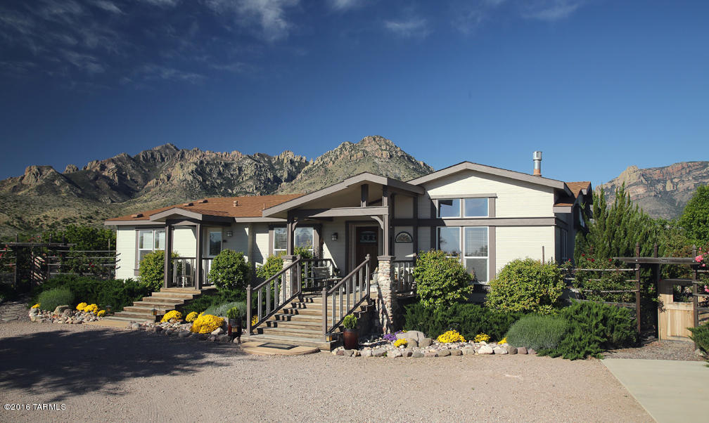 2 bedroom + den triple wide, 2 bath 2254 sf manuf home on 11.37 ac, designed for year-round outdoor living & entertaining, well maintained, move-in ready. AC, gas heat. Separate 2-car garage, shop & guest suite. Greenhouse, full RV hookup. Water features, mature landscaping on automated systems. Spa, redwood decks & flagstone patios with spectacular mountain views. Adjoins state land, fenced, terrific well. Top of the line SilverCrest w/many extras, huge kitchen w/Jenn-Air gas range, electric ovens, walk-in pantry, island & breakfast bar. Living room fireplace, family room wet bar, office/3rd bedroom. Carpet & laminate. Master bedroom walk-in closet, master bath Jacuzzi.French doors open to decks. Furniture, woodworking tools available for purchase. Seller to pay $500 toward home warranty.
