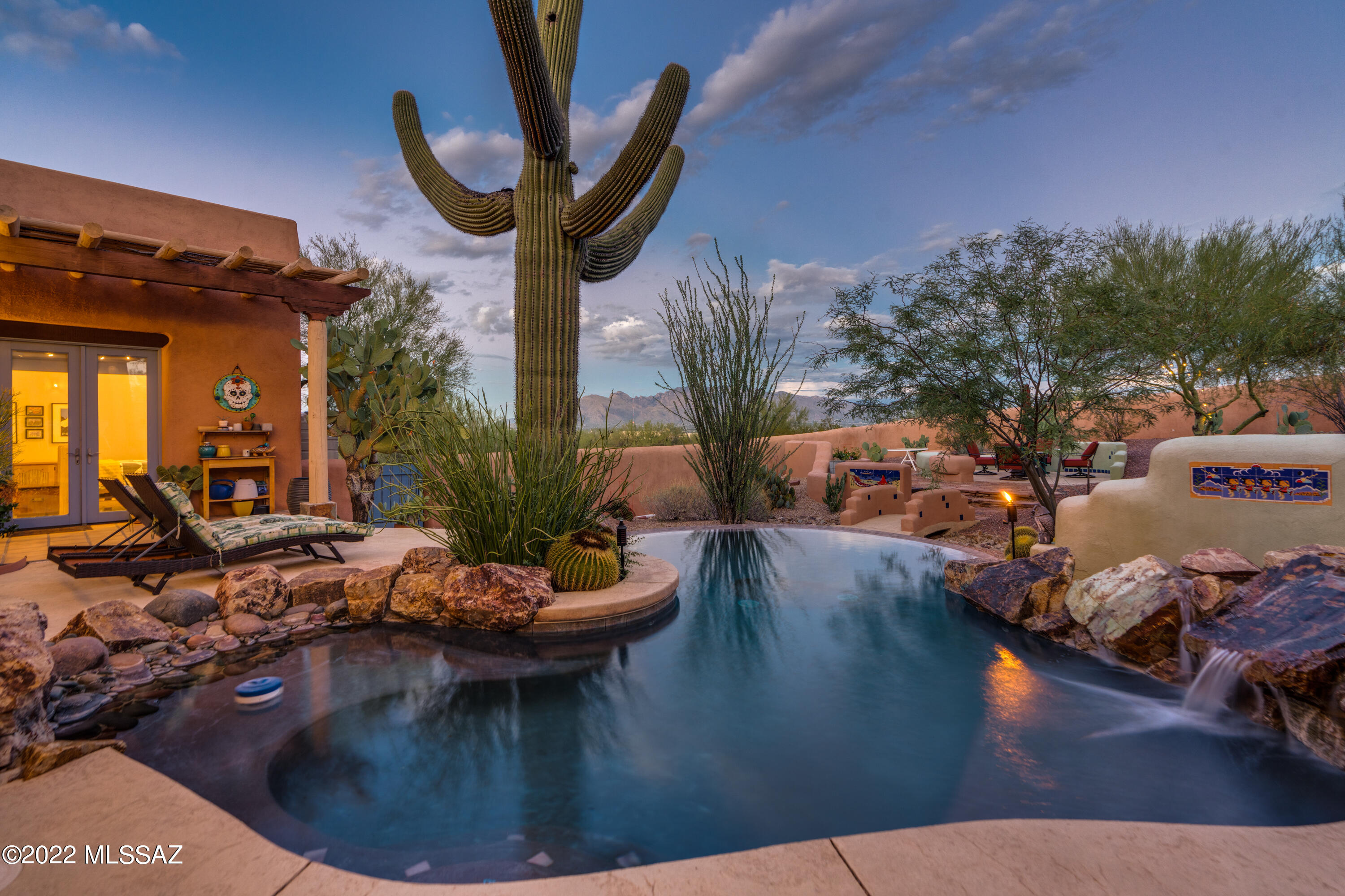 One of a kind Southwestern paradise on almost 4 acres with 360 degree views of the Catalinas and Tucson cityscape.  Custom features are at every turn from the 36'' Viking range, cement countertops, high end appliances and hand forged sinks. The open great room showcases soaring wood beamed ceilings and multiple French doors to show off the stunning desert horizon.  The home is spacious and open with a split floorplan and many new upgrades.  New whole home water filtration system, HVAC and water heater,  walls are freshly painted, 1100 gallon rainwater collection tank, upgraded landscaping and irrigation system, and new custom built chicken coop.  This luxury home is waiting for you to enjoy the million dollar views and peaceful desert lifestyle.