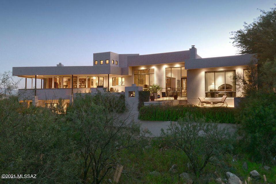 Spectacular Custom Campisano Contemporary in Prestigious Gated Ventana Canyon. Offering sweeping golf course, mountain and canyon views. One of a kind highest quality throughout. Indoor basketball court with McDonald's style play structure and workout room. There are limitless uses including a gym, dance studio or artist studio. Large home theater to enjoy a cinematic experience. Kitchen with cherry cabinets, high end appliances, warming drawer and 2 dishwashers. True his/hers office with built-in desks, grand bookshelves and alcove with daybed. Exquisite master suite with fireplace, his & her baths with walk-in closets. Truly a Masterpiece!