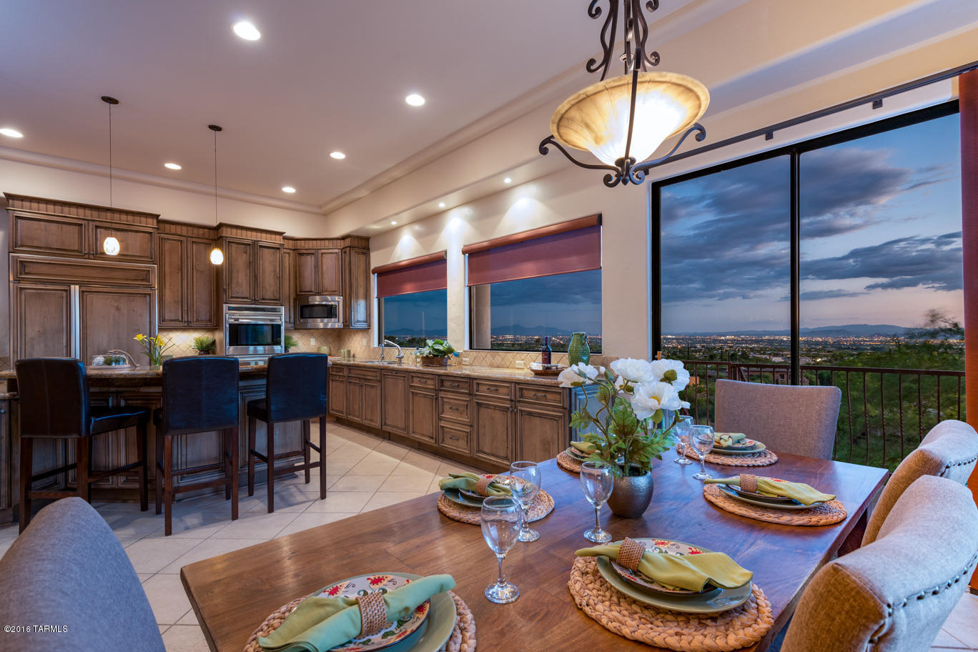 A perfect setting to enjoy the unbelievable mountain views and city lights in this established gated community of Skyline Country Club. The elevation of the building site required a carefully planned home so that all the major living areas could have impressive views. Imagine preparing meals in this kitchen that could easily accommodate family and friends with extensive granite counters with bar seating and dining table amazing windows. A great room concept with high ceilings & elegant entry define a casual contemporary life style. Easy access to the bedrooms w/interior elevator that also goes to the pool area. Just minutes from fine dining, shopping, medical facilities, U of A, and our up and coming downtown development.