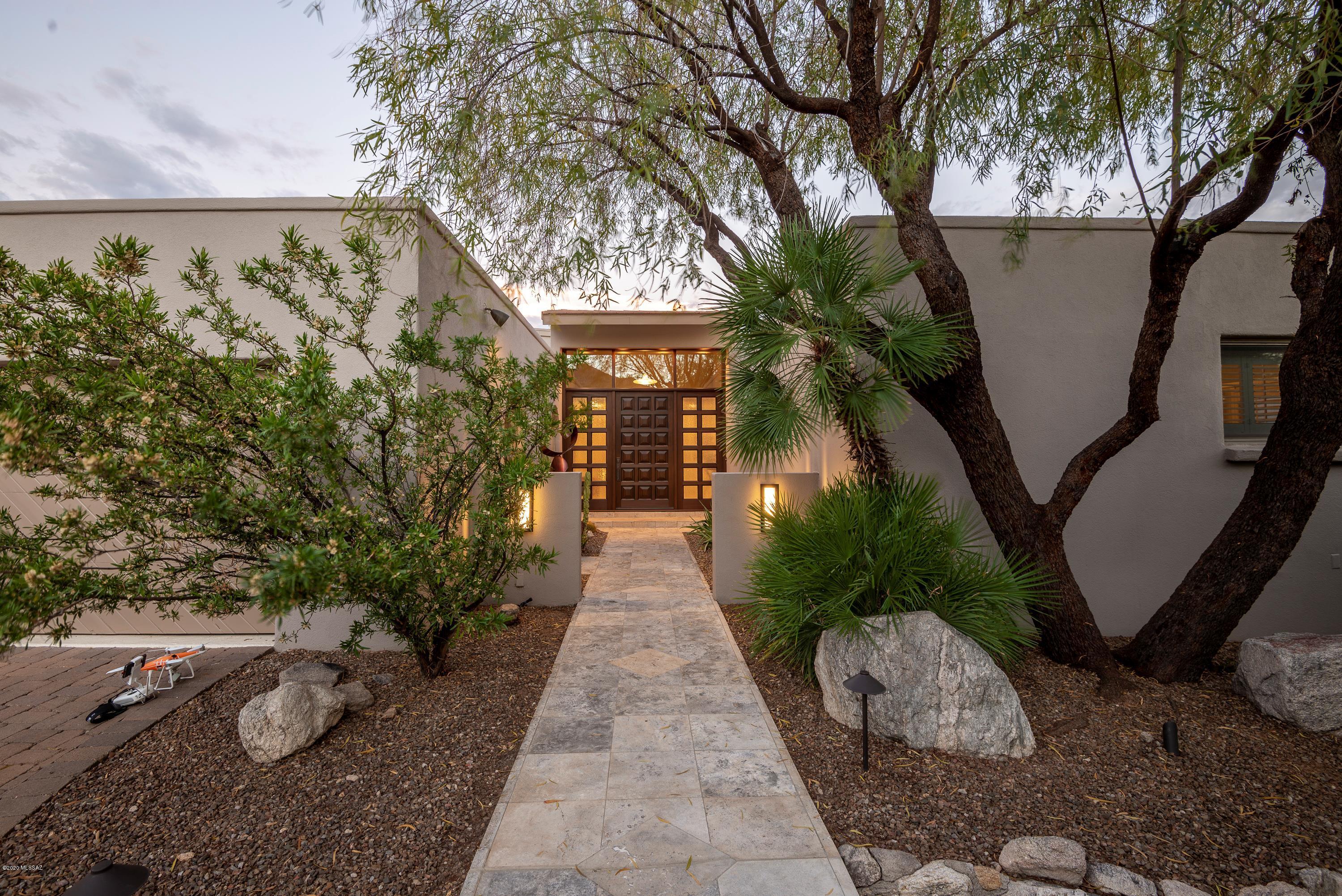 Live the Tucson lifestyle in this 4 bdrm home bordering the beautiful Skyline golf course. Incredible mountain, city & sunset views.  Cook's dream kitchen has quartz counters, Wolf induction stove, double ovens & warming drawer. 2 Dishwashers, ice maker, beverage fridge and a center island large enough to prep and entertain guests. The large kitchen windows take full advantage of mountain views. All main living is on one level. Guest quarters/Studio are on the lower level. 2 Newer HVAC syestems. Relax and enjoy the sparkling pool as you gaze at the city lights. Back patio is perfect for entertaining all year with Sparkling Pool, built in fireplace, BBQ and spacious Patios. This is outdoor living at its finest.