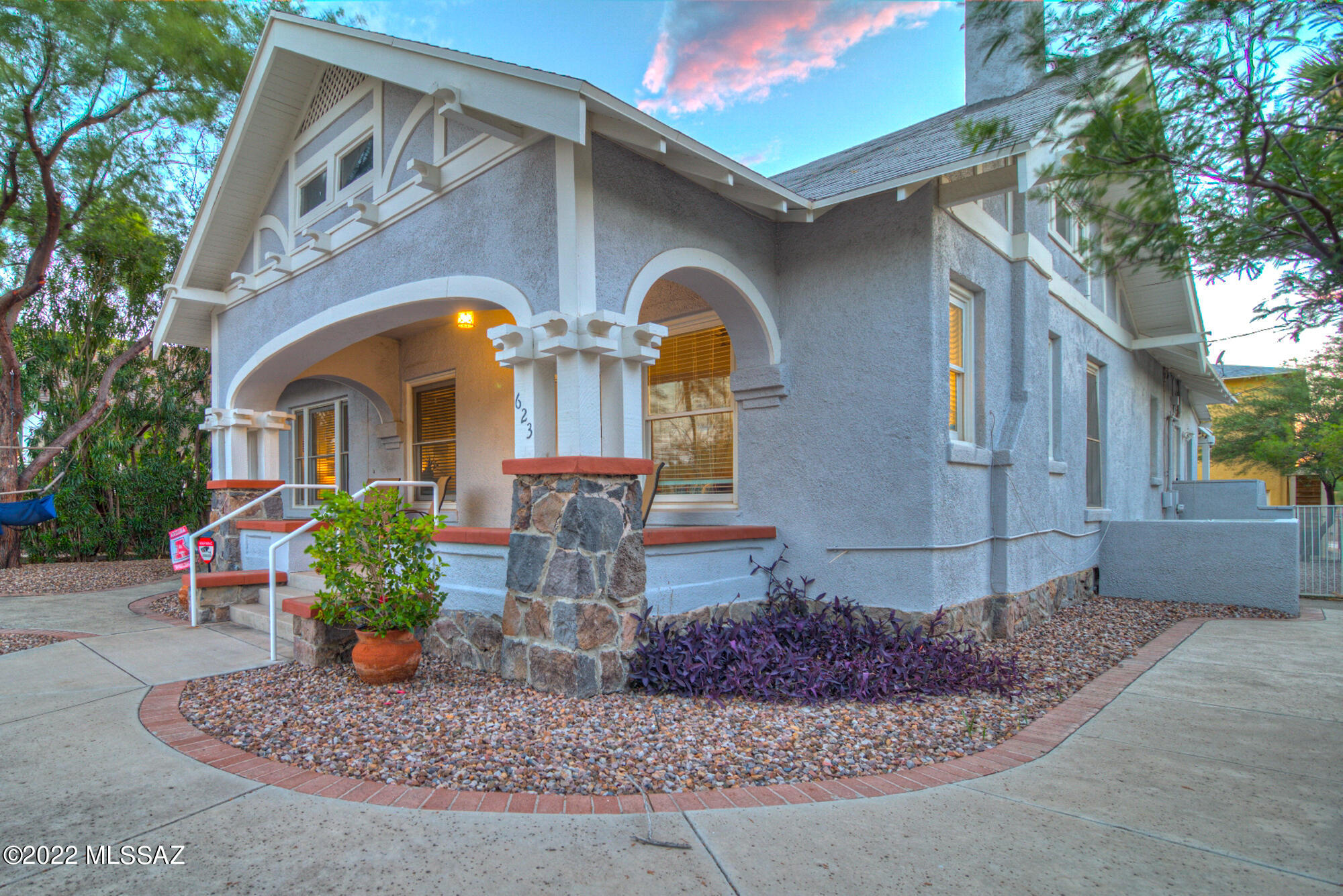 Charming Bungalow style home from the 1900's. Beautiful front courtyard and large covered front porch. Main house has 3 bedrooms, 3.5 bathrooms, white oak floors freshly refinished and restored to their original luster.  Master has private bath w/tub and shower, upgraded kitchen with soap stone counters & stainless steel appliances. Large windows throughout. Each bedroom has a private bathroom and a half bath off the living room for guests. Each room also w/separate entrance from outside.  Separate 2-bedroom 2-bathroom home built with white oak floors, great room and split floor plan.  Security system w/cameras surround property. Electronic gate and tons of off-street gated parking! Walking distance to 4th Avenue, light rail to downtown or the U of A. Great investment property!