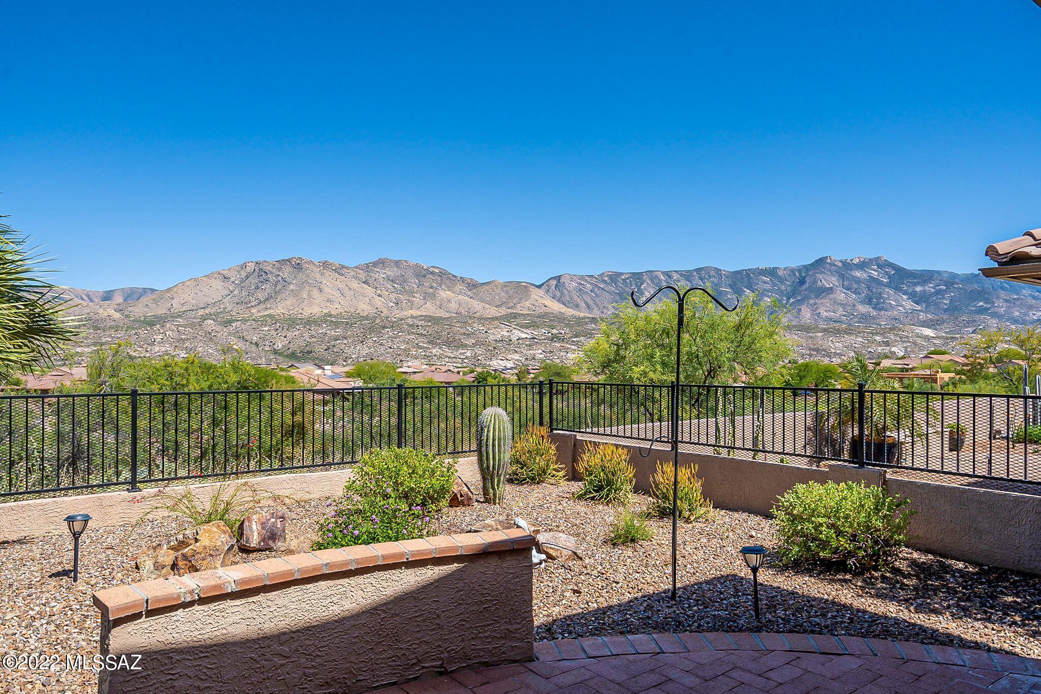 Enjoy fabulous panoramic mountain views from almost any room in the home!  This Ponderosa Model has open airy vaulted ceiling with beautiful wood kitchen cabinets, granite counter tops, Kitchen Aid appliances, a modern Blanco sink, wine cooler, beehive fireplace in the great room, updated bathrooms, solar tubes, neutral color tile and carpet flooring. the beautiful low maintenance landscaping has a newer irrigation system.  Owner owned solar system dramatically lowers electricity bills. Newer HVAC system, 2.5 car/golf course extended garage. air conditioned garage.  Full covered patio which is great for entertaining!  Make this fabulous home yours.  The garage is extended, extra lighting.