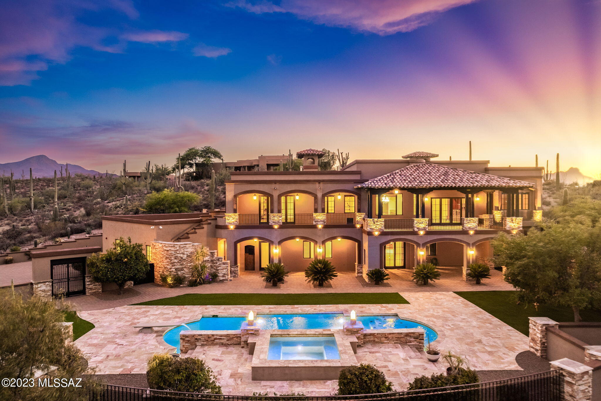 Elevate Your Lifestyle: Immerse Yourself in Santa Barbara Splendor with Unmatched Tucson Valley and City Views. Ensuring ultimate privacy and exclusivity, prepare to be enchanted by breathtaking daily sunsets that transition from golden hues to rich purple shades, showcasing nature's brilliance. Step inside the grand foyer, where your eye draws you to the spiral staircase and custom inlaid marble floors setting the stage for the splendor that lies beyond. This Santa Barbara estate exudes authentic charm and character, offering a well-designed layout with endless possibilities to suit your unique needs. Situated on 3.3 acres, the property is a true masterpiece, adorned with stunning stacked stone and exposed wood beams both inside and out, radiating an air of elegance and luxury. Proudly standing on a hill, the estate boasts an impressive 6,246 square feet of opulence, featuring 5 bedrooms accented with travertine flooring in ensuite bathrooms, 6 baths, two gas fireplaces, and a near 2,000 sqft.  4-car garage to cater to all your desires and indulgences. Outside, the panoramic views take center stage, with the Santa Catalina Mountains stretching peak-to-peak and unrivaled vistas of the Tucson Valley. Your private haven awaits in the backyard, featuring a 40' heated pool and spa with travertine deck, entire backyard with turf, outdoor shower, and various fruit trees, inviting you to bask in tranquil luxury and enjoy blissful serenity every day. Double French doors leads to a balcony spanning the entire floor, offering 180-degree views that allow you to savor both the sunrise over the Rincons and the sunset over the Tucson Mountains. At night, the city lights twinkle in the distance, creating a magical ambiance. With an option to enter the upper level of the home via elevator, the second wing hosts a gourmet chef's kitchen adjoining formal living and dining rooms, complemented by a stone fireplace, generous living, and entertaining spaces. The master bedroom serves as a private retreat, complete with a palatial bathroom and a double stone fireplace, wine fridge and double French door access to balcony.

On the lower level, an entertainer's dream awaits with a grand great room, entertainment center and billiard area thoughtfully appointed with a secondary kitchenette, a large peninsula is anchored by industrial black pendant lights, accented stacked stone, and wood beams. This level also features beautiful alder wood cabinetry, one more bedroom with ensuite bathroom, and a dedicated office space, pool bath, providing ample space for both family and guests. A large double French door leading to the outside makes the space a quintessential example of the best of indoor outdoor Tucson living. Bordering Saguaro National Park and 6 minutes from award-winning charter school, this estate not only captivates visually but also ensures modern comforts and peace of mind, with seamless integration of modern technology, including a 20-camera security system, commercial-grade wifi throughout, custom wrought iron fencing, Pella windows and doors, and 13 skylights invite streaming natural light into the home, among others. Elevate your lifestyle, bask in the glory of enchanting sunsets, and immerse yourself in the splendor of unmatched Tucson city views.
