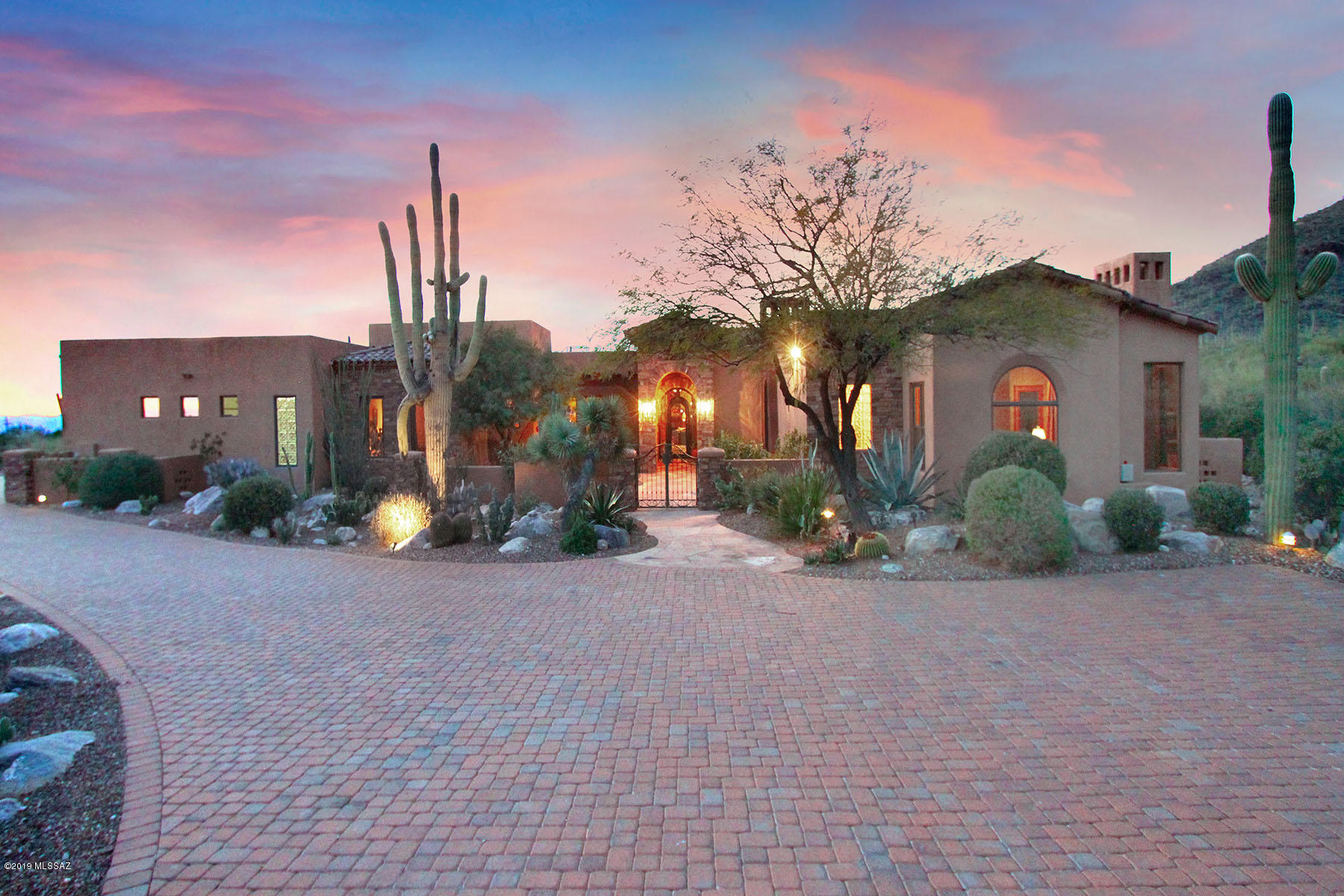Amazing Spanish Colonial custom built 5426 sq ft.home w/guest casita in the prestigious gated community of Pima Canyon Est. is sited on 2.8 acres of lush vegetation to capture spectacular city/mtn views. This home boasts 3 bedroom ensuites in main home & spacious detached guest casita w/bedroom, living room w/Cantera FP and kitchenette. Master suite w/his & her baths, steam shower, sitting room w/FP leads to private covered patio overlooking serene backyard w/pool/spa. Other features include den w/hand scraped walnut floors, wire brushed Alder doors throughout, home theatre, Cantera FP's, tumbled Travertine floors and gourmet kitchen w/Wolf, Sub-Zero and Asko appl. You will relish entertaining in outdoor living spaces with multiple covered patios, designer pool/spa and outdoor FP.