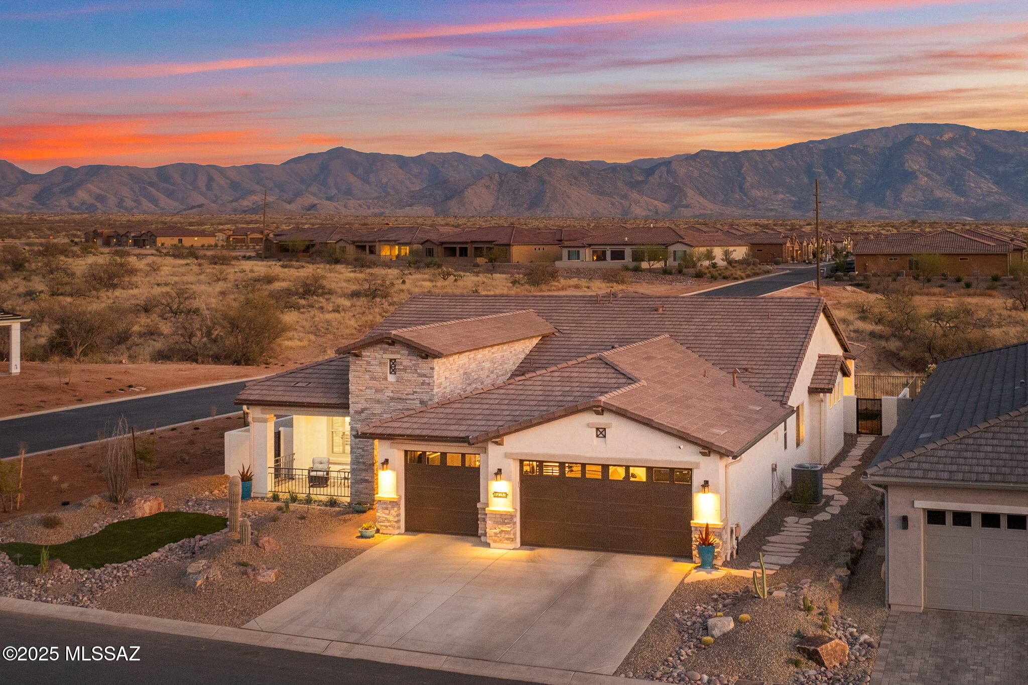 Major Price Drop- Seller is motivated! Why wait to build when you can move into your dream home today! This brand-new Avalon sits on an amazing corner lot with stunning views of the Catalina Mountains and has every upgrade imaginable. Finishes selected are in a neutral color palette giving the home a warm and relaxing feel. You are greeted by a wonderful front covered patio, brand new landscaping, and upgraded exterior with stone accents. Home has upgraded French oak LVP flooring throughout with upgraded carpet in bedrooms. Chef's kitchen w/beautiful cognac alder cabinets, high end quartz counters with waterfall edge, custom pendant lights, and GE Signature s/s appliances. Butler's kitchen w/extra cabinets plus walk in storage pantry. Open great room with built in cabinetry & wine fridge. Dining room has built in floating cabinet, perfect to use as a buffet for entertaining, and designer lighting. Huge primary suite with upgraded enlarged shower, dual vanities, and custom walk-in closet. Guest bedroom with ensuite plus additional den/office. Majestic mountain views from the amazing extended outdoor covered patio. Contemporary style outdoor fireplace, electric sunshades, and brand-new landscaping. All this backing to natural desert open space for added privacy. Oversized three car garage with 4' extension, epoxy floors, extended driveway, whole house filtration system, and soft water system. Add to that the wonderful amenities of this premier active adult community with golf, tennis, pickleball, indoor/outdoor pools, hot tub, fitness center, on-site restaurants, and tons of clubs. This home has it all. Too many upgrades to list, see Documents. Builder warranty still in place.