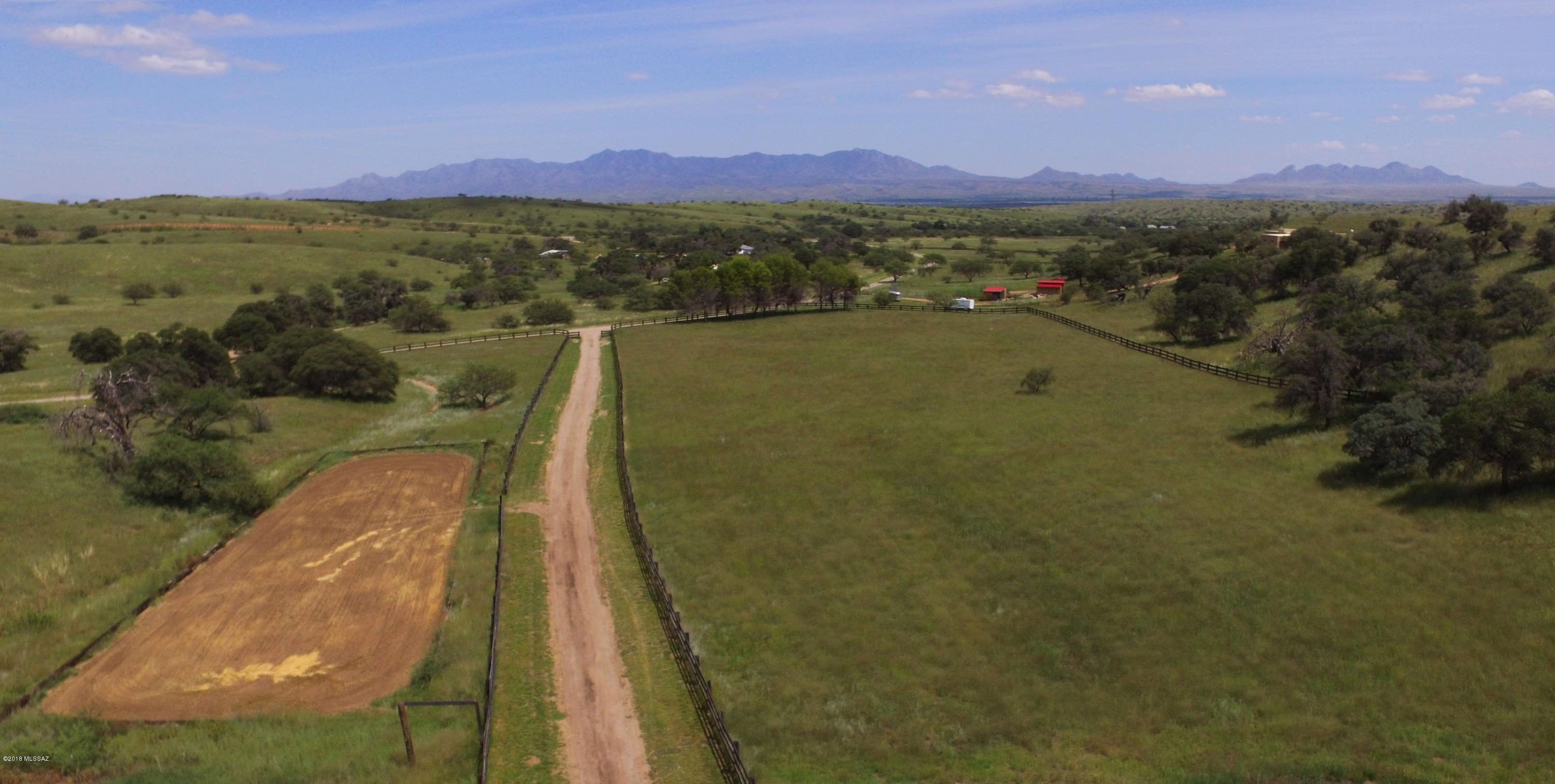 This oak studded equestrian property hits all the hot buttons:Grassland pastures, exquisite horse facilities, a gracious 3,861sf home, 1,600+/-sf 2 BR caretaker/guest house, paved road access, bordering National Forest & 45 minutes to the Tucson Arpt & other Tucson amenities.Located just 10 minutes north of Sonoita in Singing Valley Ranch, the brick home roof has a large master bedroom with a spacious walk-in closet & two other bedrooms in a separate wing, spacious living room with wood burning fireplace, chef’s kitchen with pantry & a formal dining room.Complementing the livability is an Arizona room running the length of the house & an enclosed courtyard off the kitchen with a greenhouse.Horse facilities include:3 stall barn with tack room & feed room, riding arena, fenced & cross fenc