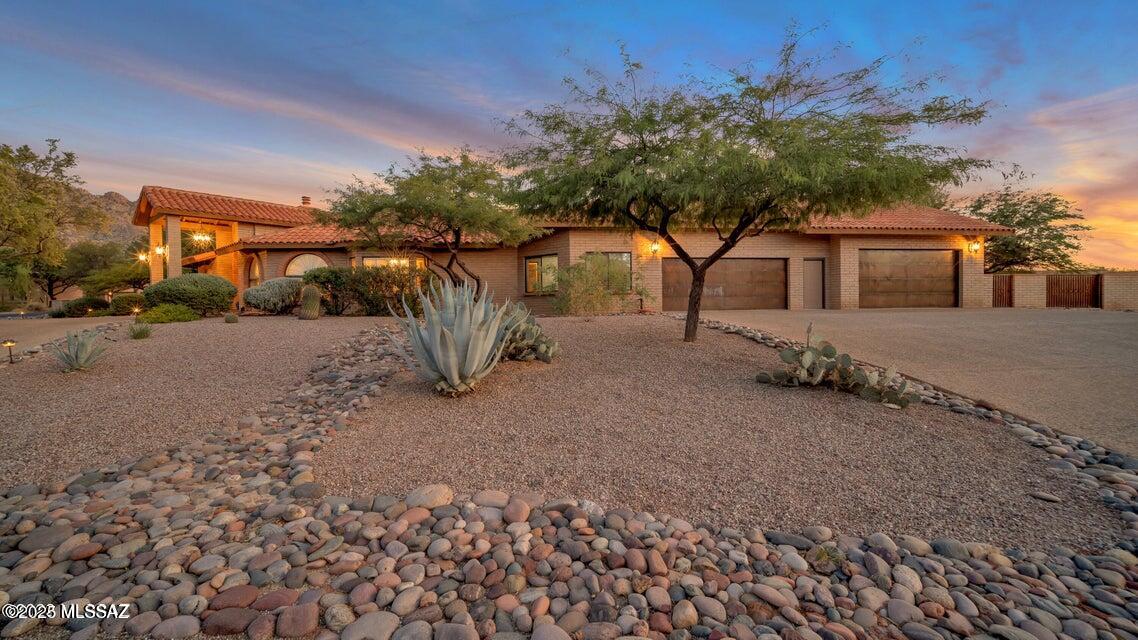 Stunning estate located in the heart of Oro Valley in Oro Valley Country Club. 5 BD/3 BA/3,671 Sq.Ft home offers separate living room & family room w/2 sided fireplace, formal dining area & casual kitchen dining. Heated/cooled 4 car garage has plenty of room & has an attic for additional storage space.  Backyard is a true oasis & entertainers paradise w/mature landscaping, grass, covered patio, outdoor gas fireplace, basketball 1/2 court, sparkling pool & spa & large ramada w/built-in BBQ.